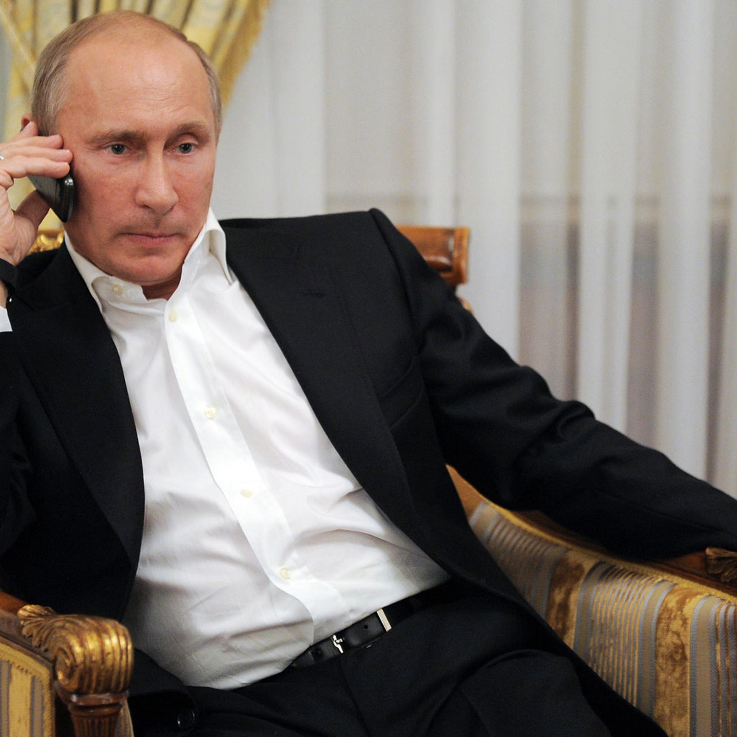 President Putin phones as he watches TV in his residence in Novo-Ogarevo outside Moscow in 2012.