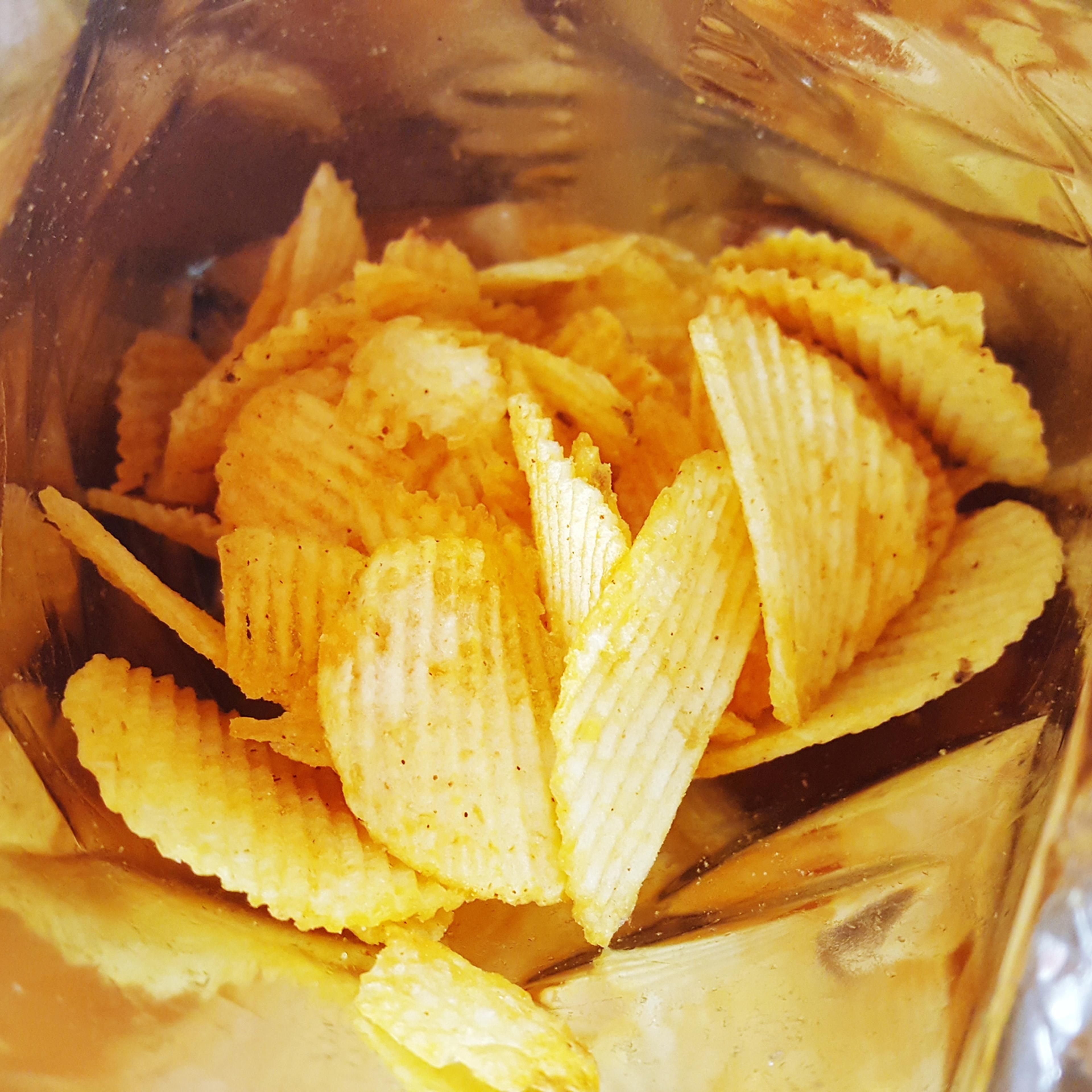 Close-Up Of Potato Chips In Foil Container