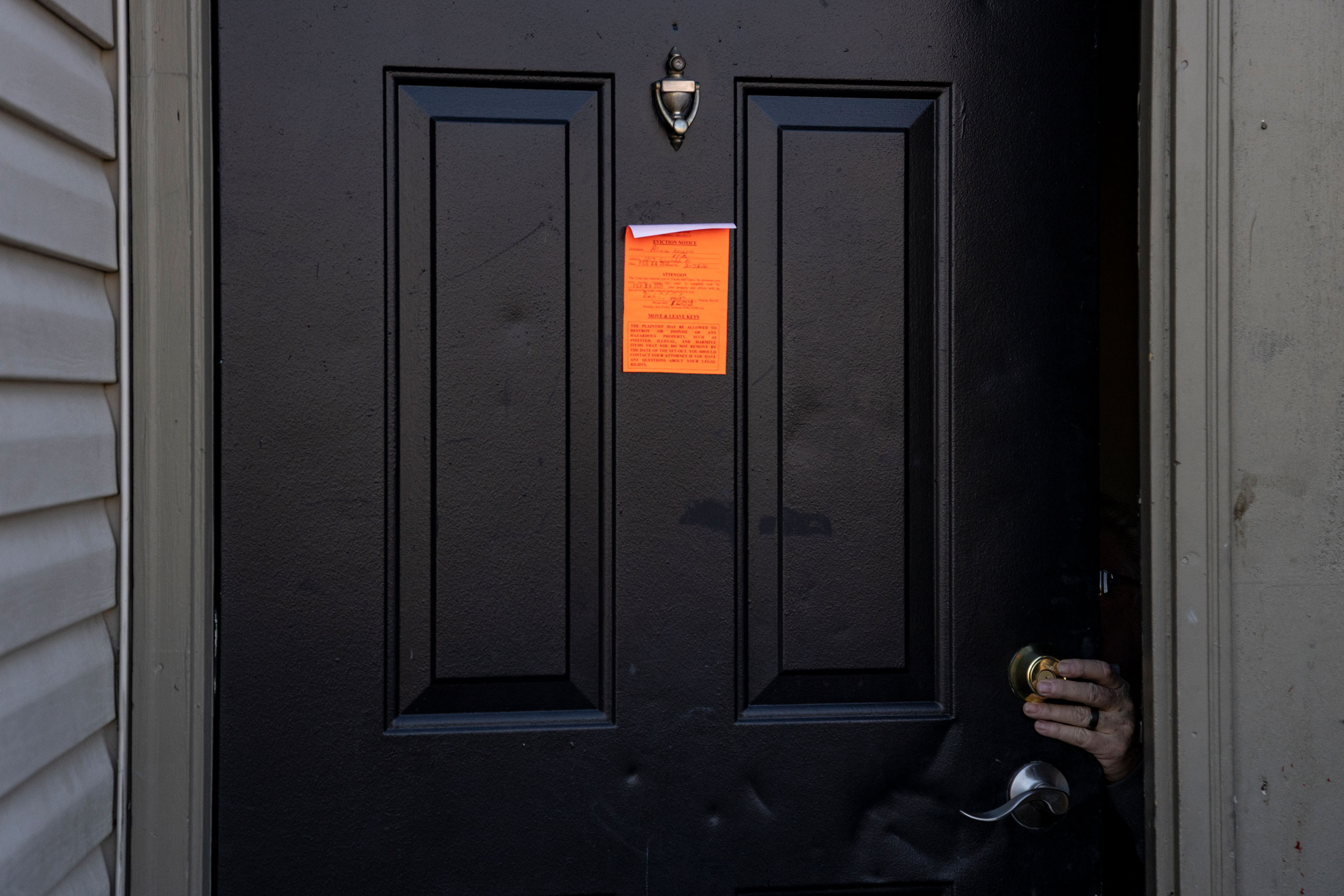 An eviction notice is posted and the lock is changed on a door in the unincorporated community of Galloway west of Columbus, Ohio on March 3, 2021 .