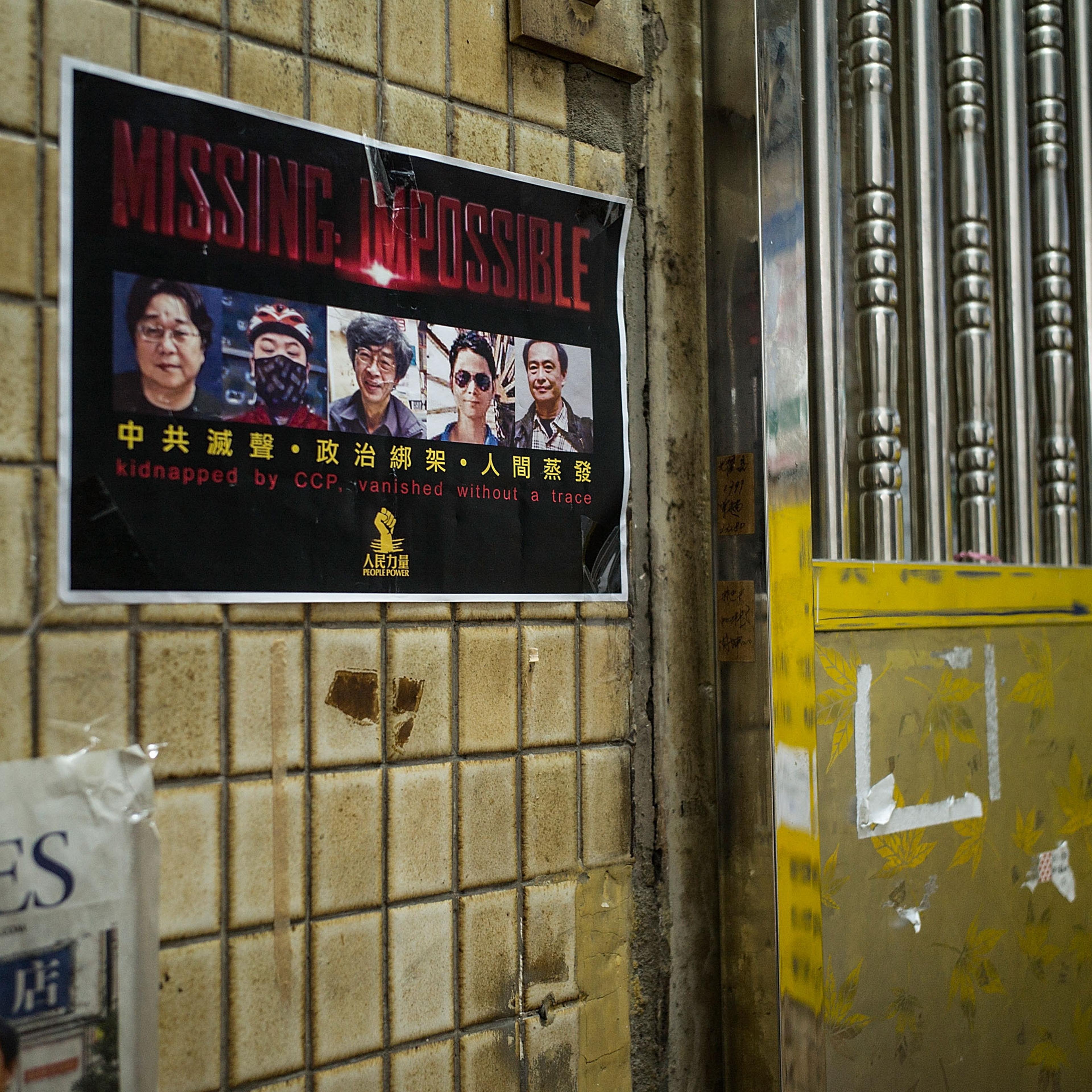 A poster showing five booksellers from the publishing house Mighty Current Media outside the closed Causeway Bay Books store on March 1, 2016, in Hong Kong