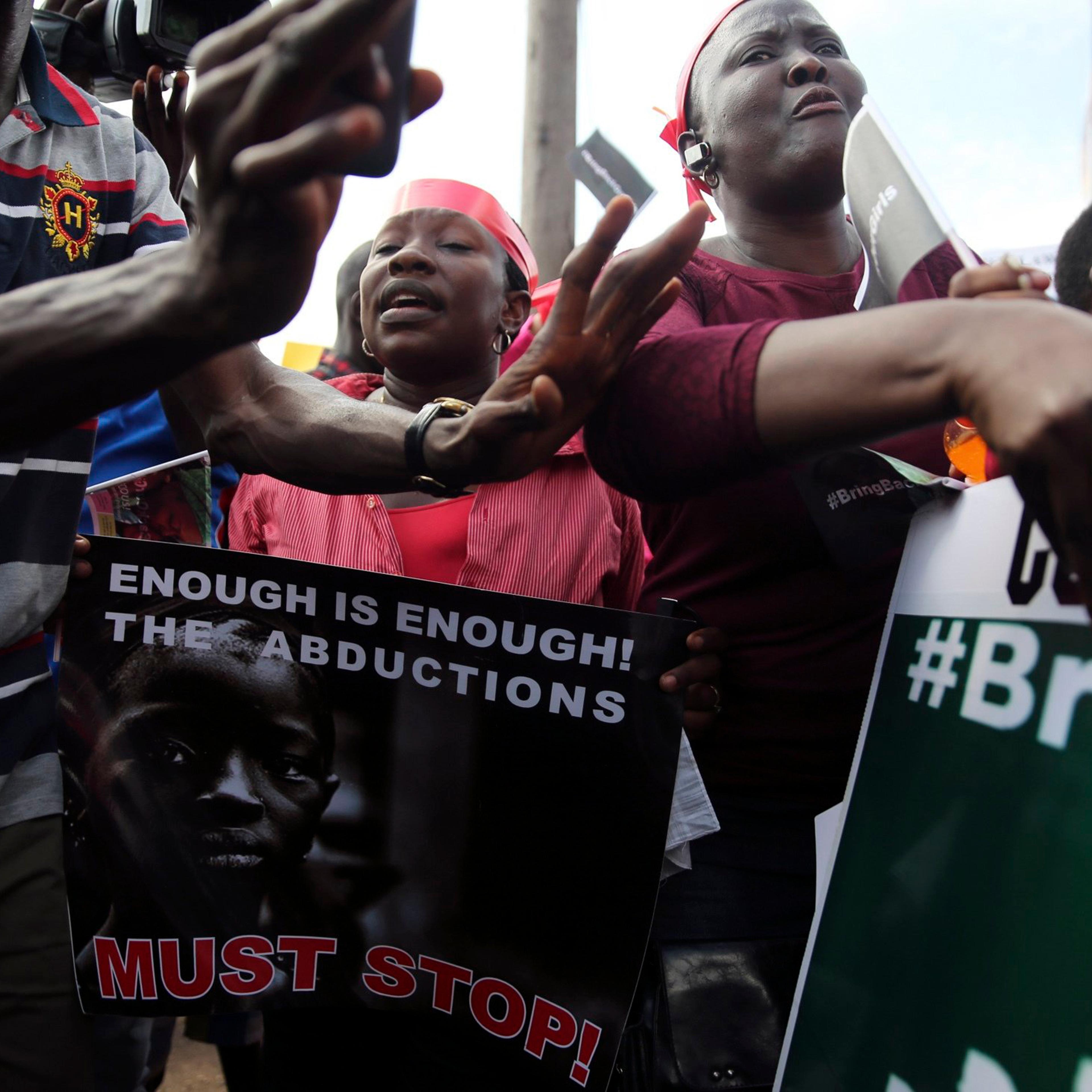 People holding signs take part in a protest demanding the release of abducted secondary school girls from the remote village of Chibok, in Lagos, May 5, 2014.