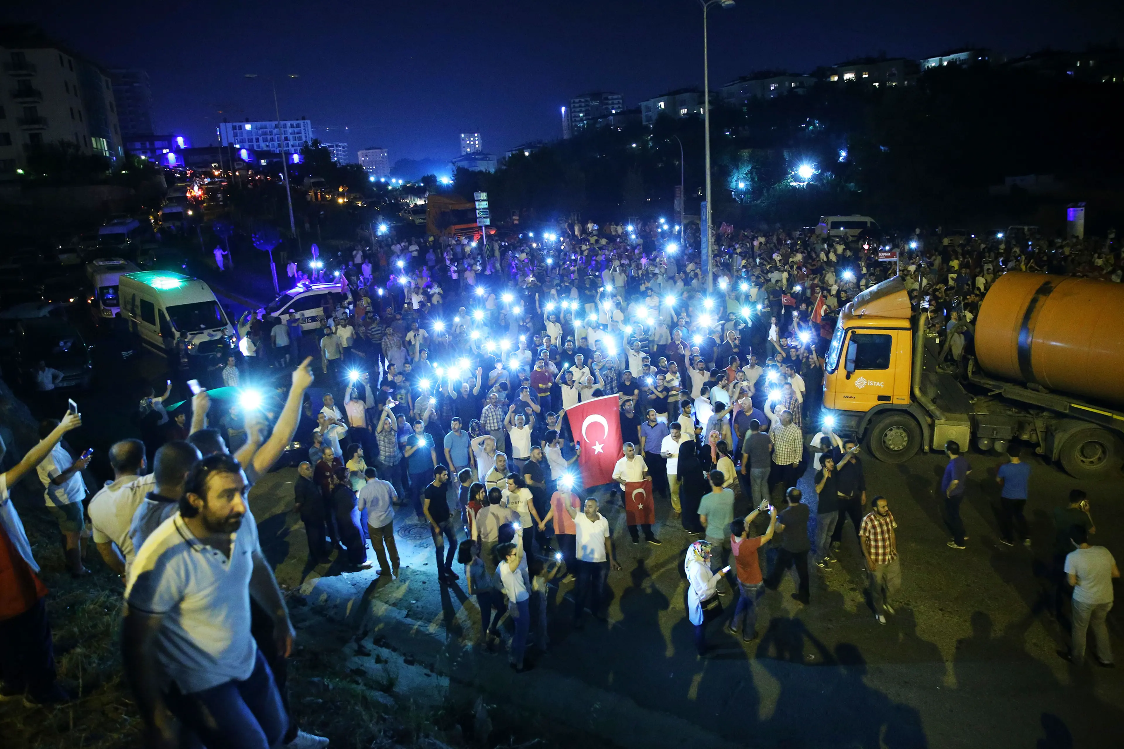 People gather with their mobile phones to react against the military coup attempt in the Tuzla District of Istanbul, Turkey, on July 16, 2016.