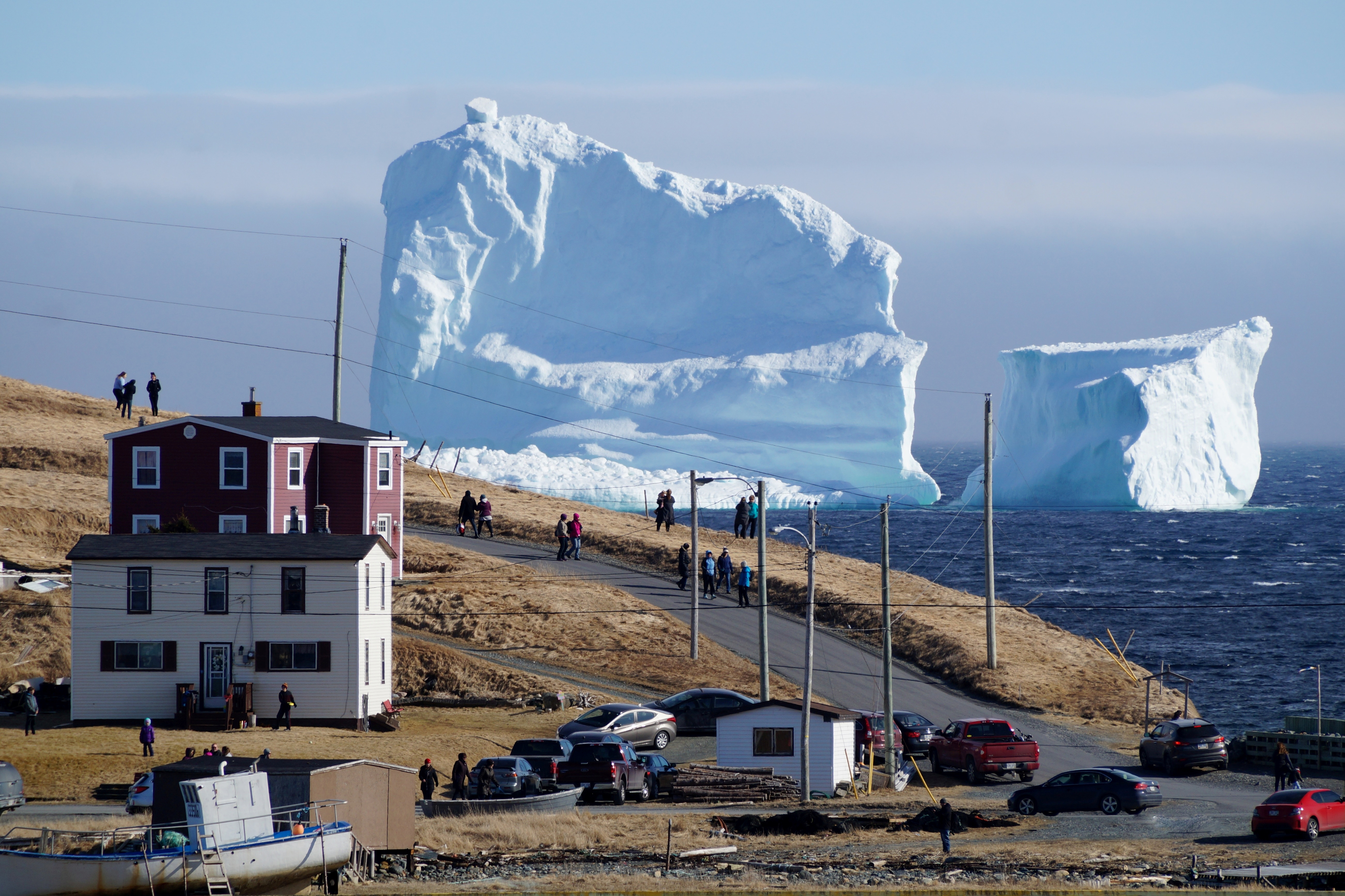 Residents view the first iceberg of the season as it passes the South Shore of Newfoundland