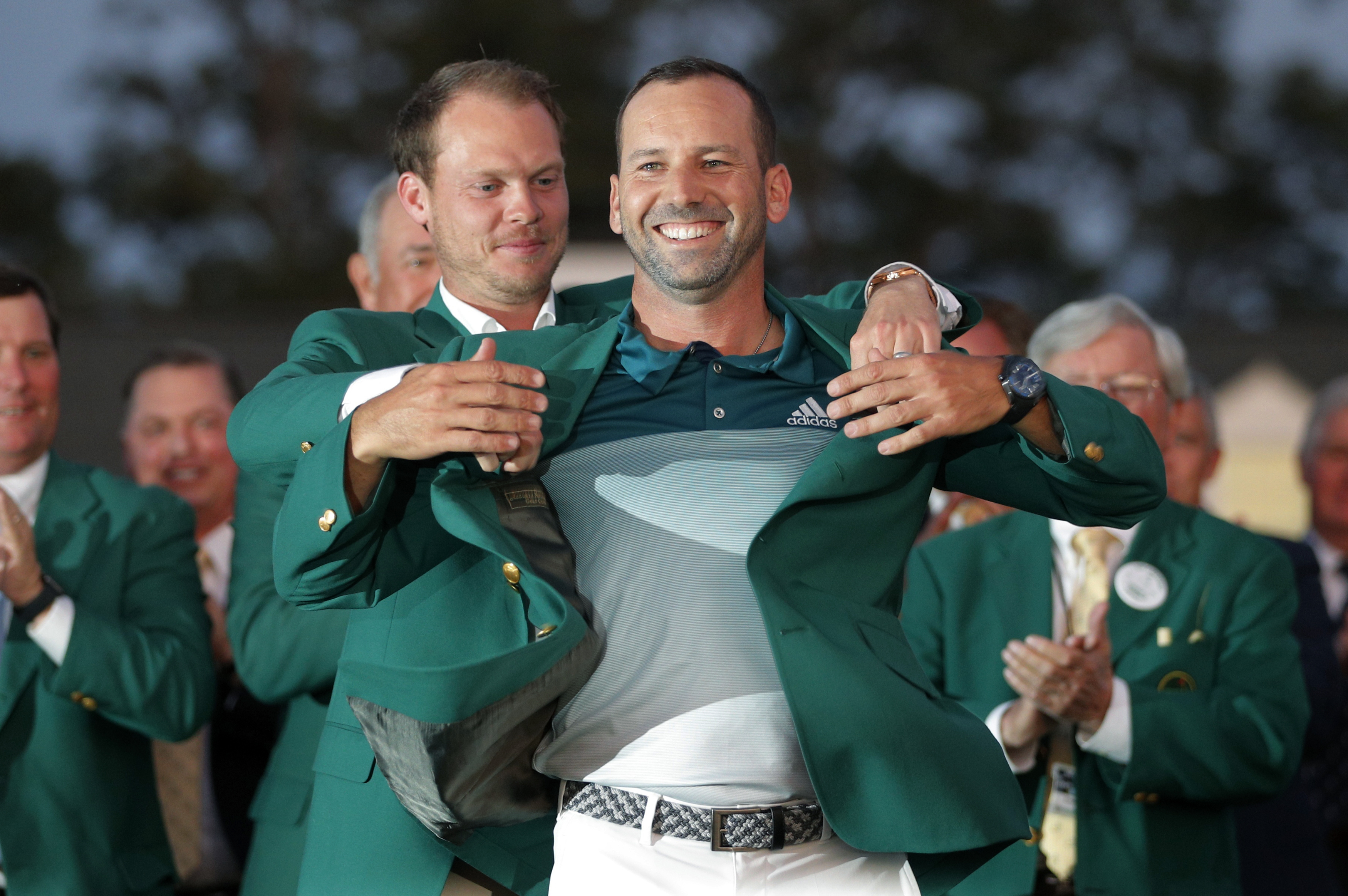 Garcia of Spain is presented the green jacket by Willett of England after Garcia won the 2017 Masters in Augusta