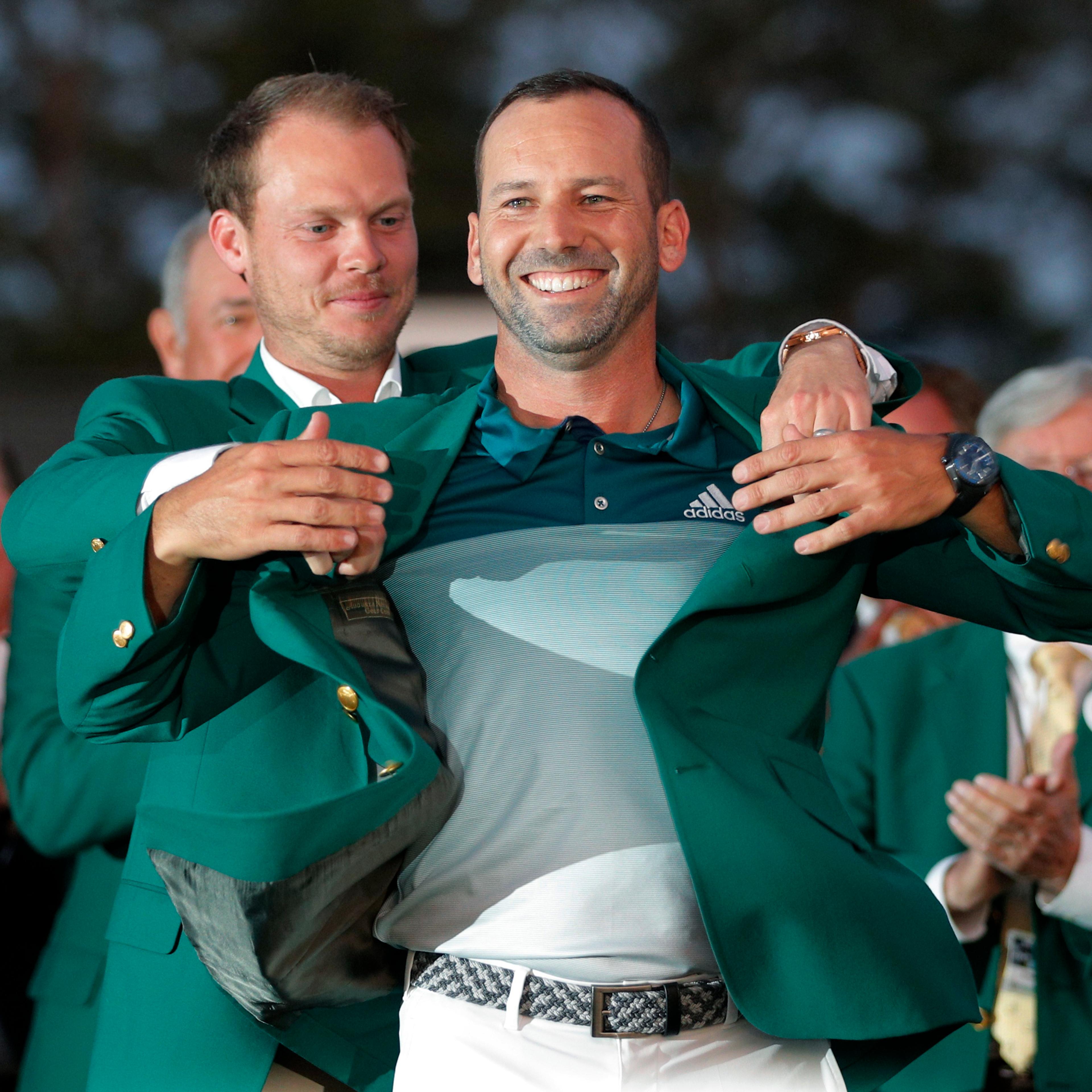 Garcia of Spain is presented the green jacket by Willett of England after Garcia won the 2017 Masters in Augusta