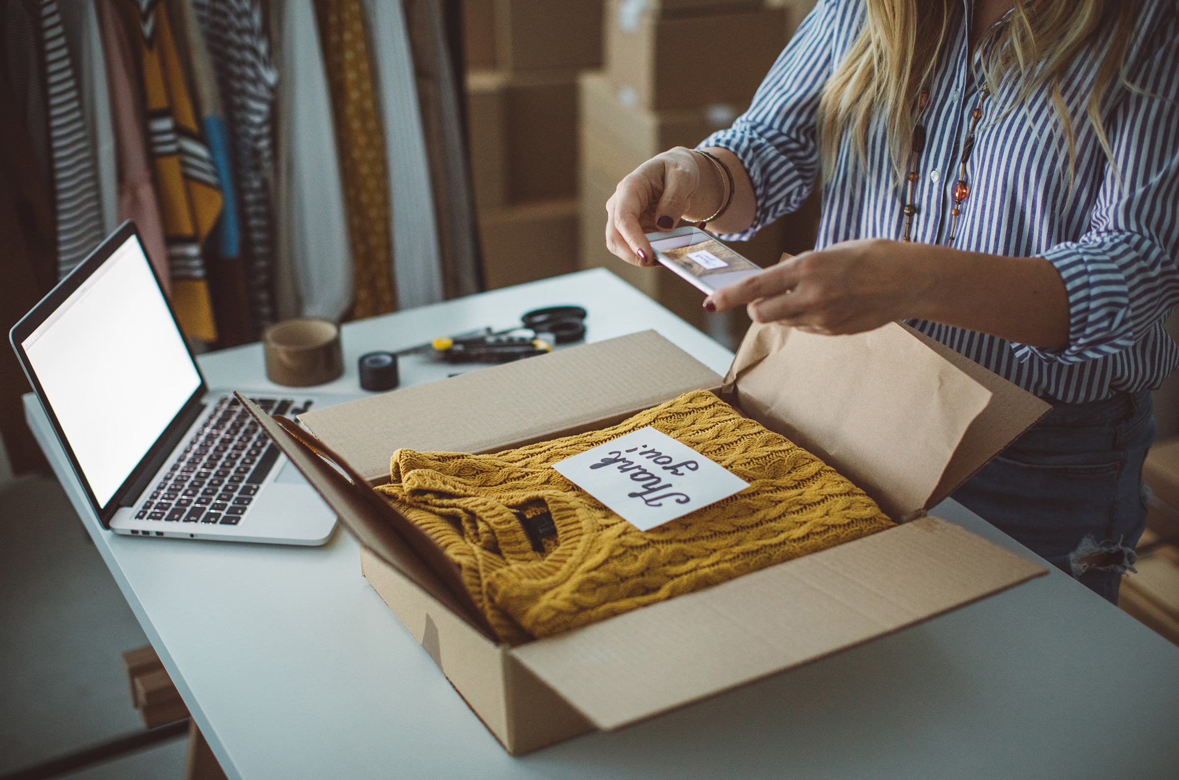 Small business owner packing boxes