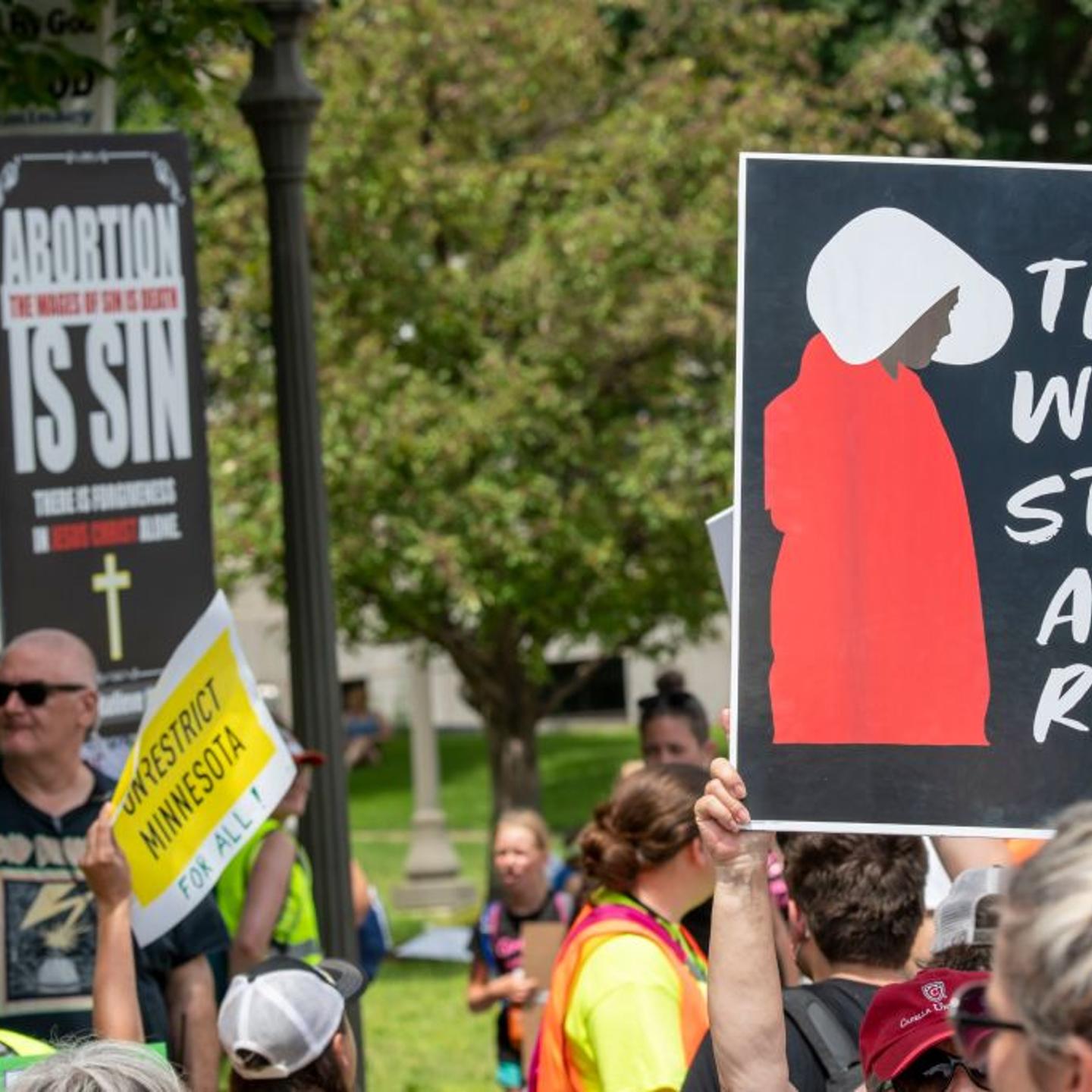 St. Paul, Minnesota. July 17, 2022. Rally in support of legal abortion access after the U.S. Supreme court overturned the federal constitutional right to an abortion. Anti and pro demonstraters hold up signs showing their different opinions.