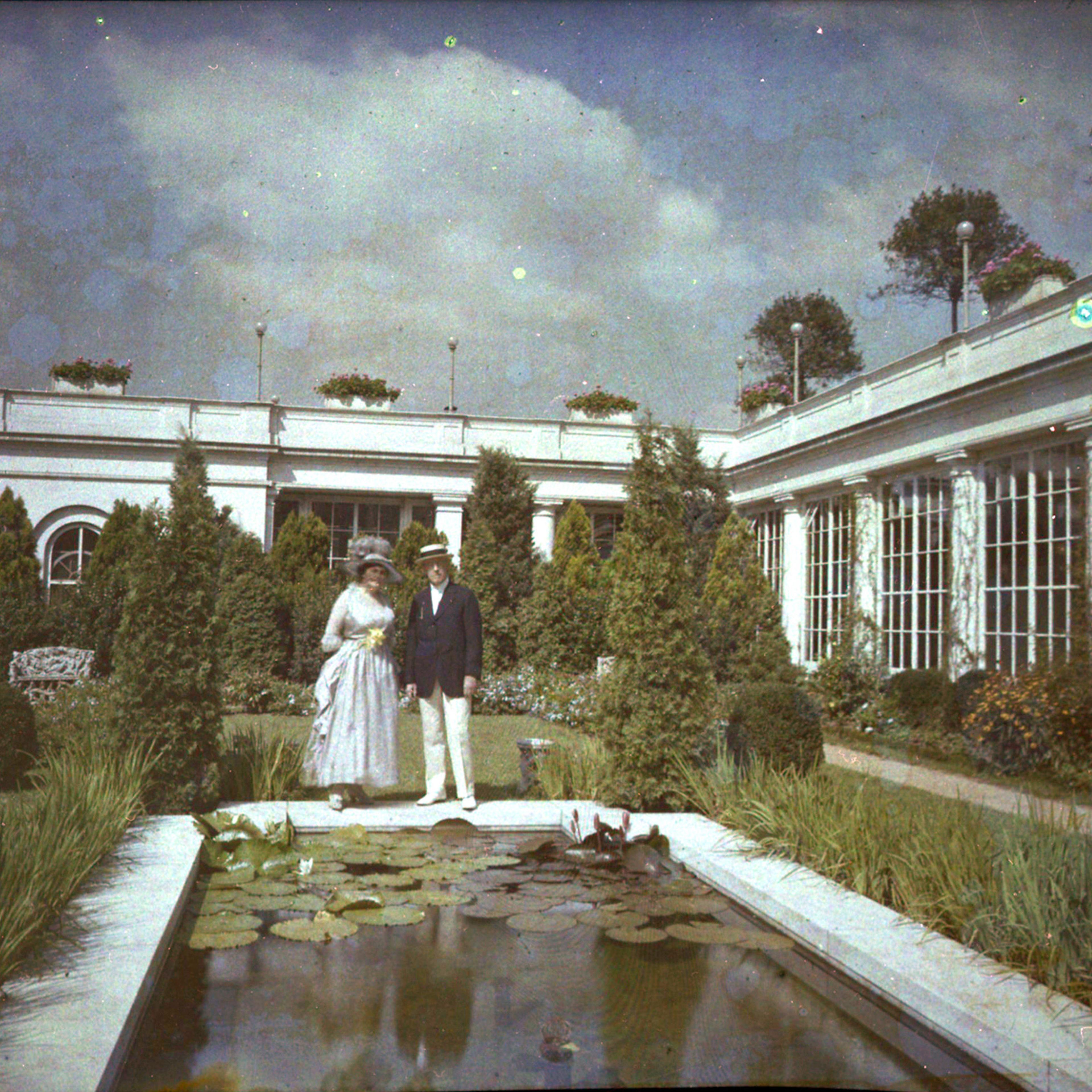 Edith and Woodrow Wilson enjoy the East Garden in their summer finery.