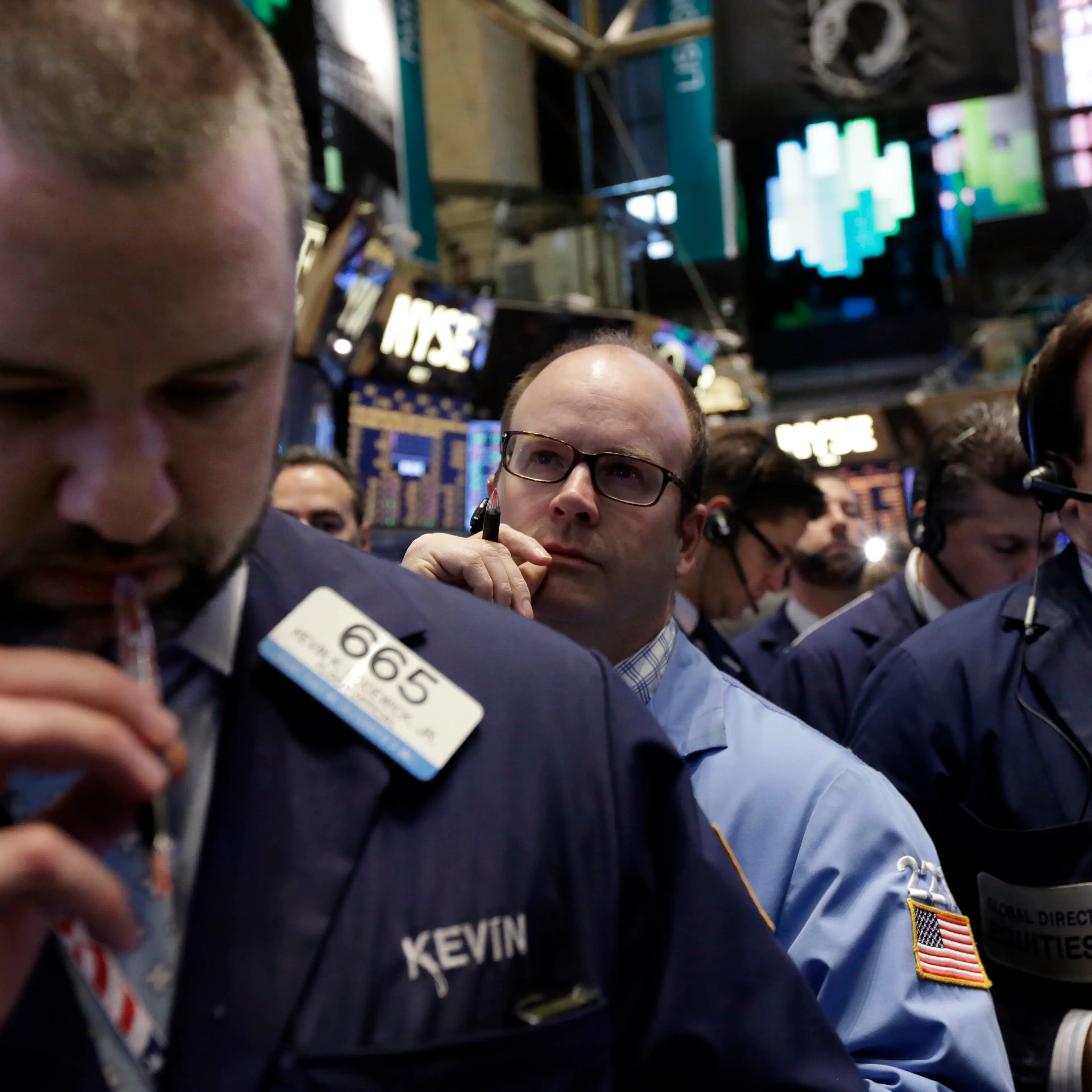 Traders work on the floor of the New York Stock Exchange