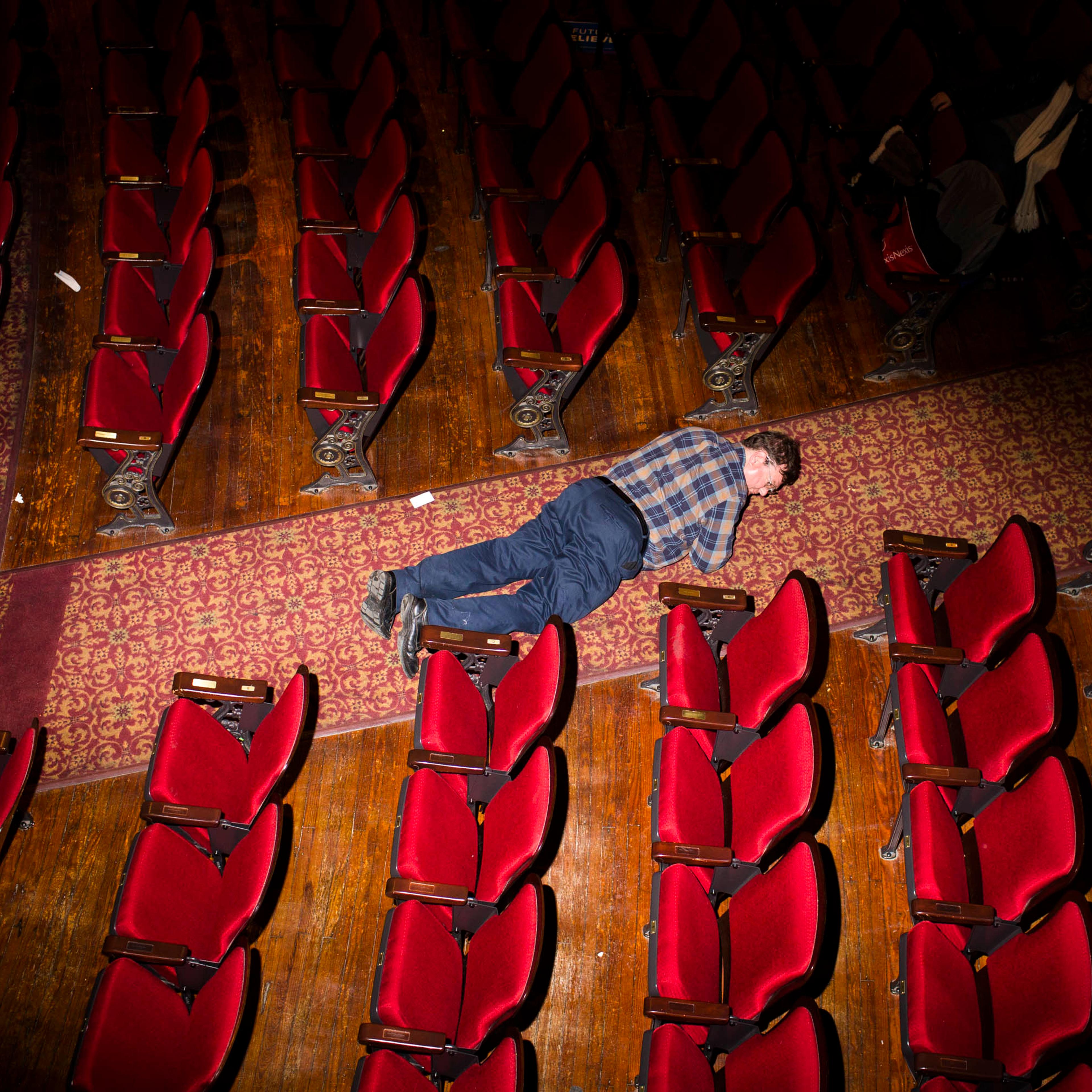 A man looks for something he dropped at the Palace Theater, where Democratic presidential candidate, Vermont Sen. Bernie Sanders held a campaign event on Feb. 8, 2016, in Manchester, N.H.
