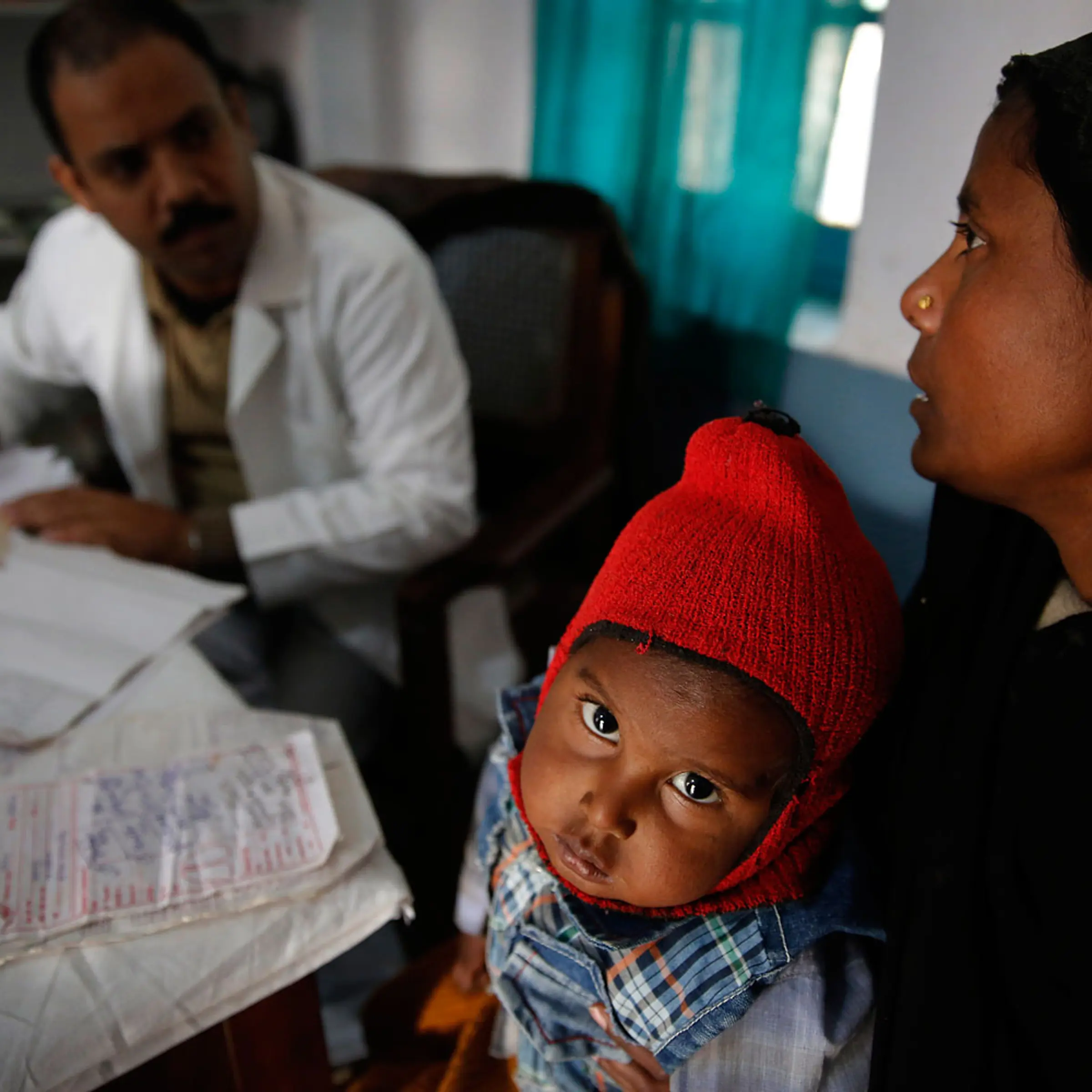 A doctor attends to Anwar, 4, infected with tuberculosis at the Kashi Vidyapith block hospital, Kotawa near Varanasi, India, Feb. 1, 2014.