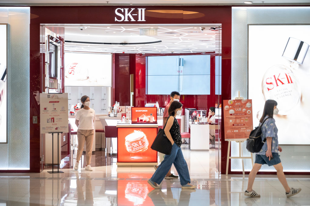 Shoppers walk past the Japanese cosmetics brand SK-II store