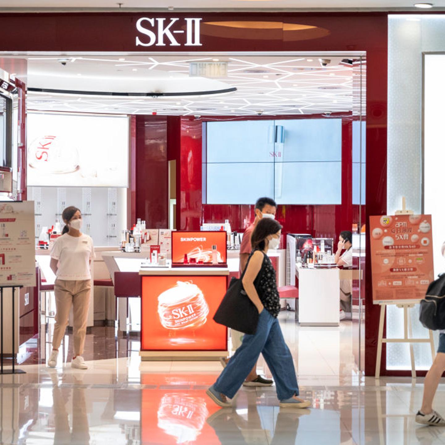 Shoppers walk past the Japanese cosmetics brand SK-II store