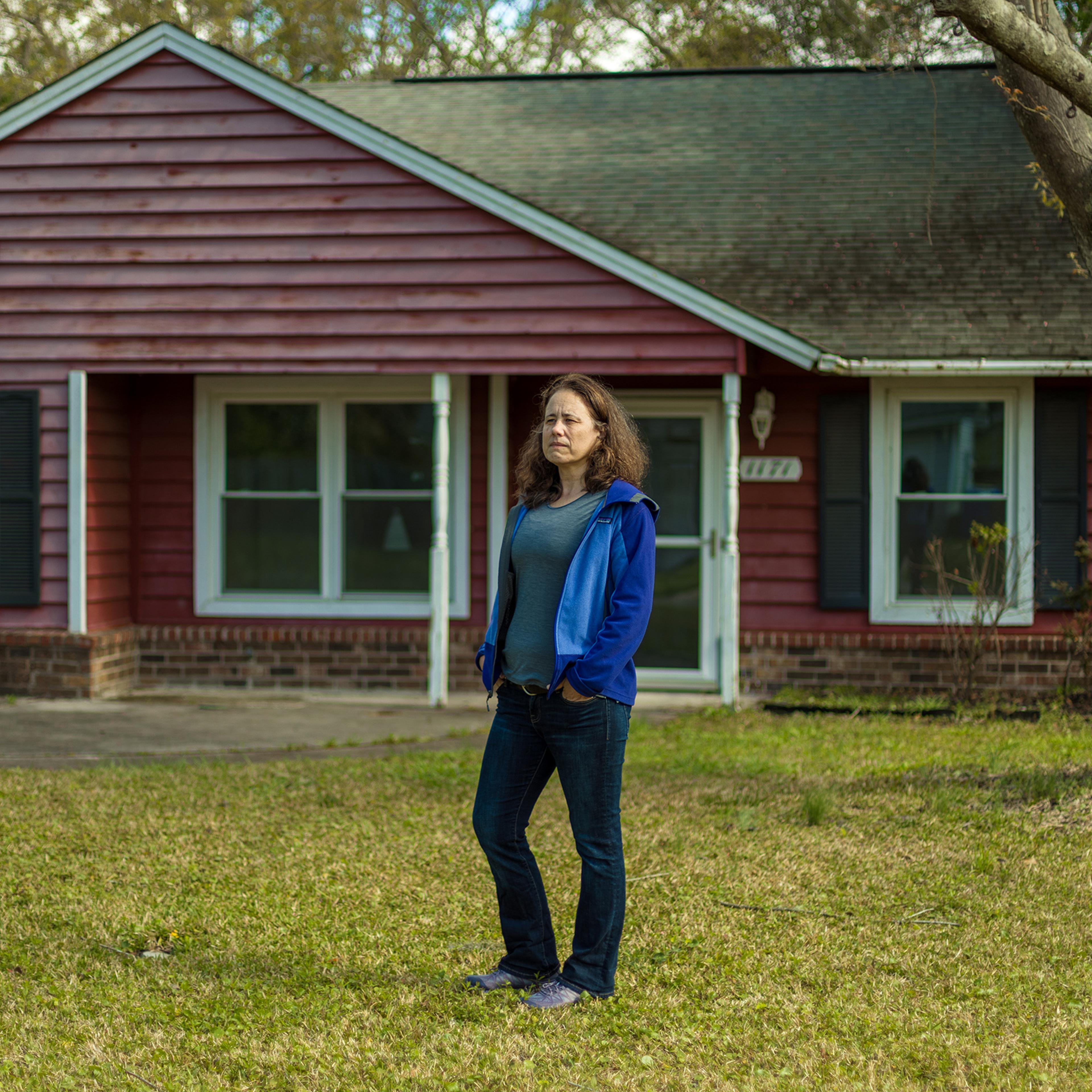 Ana Zimmerman stands in front her former home. that she owned the home between 2005 and 2019.