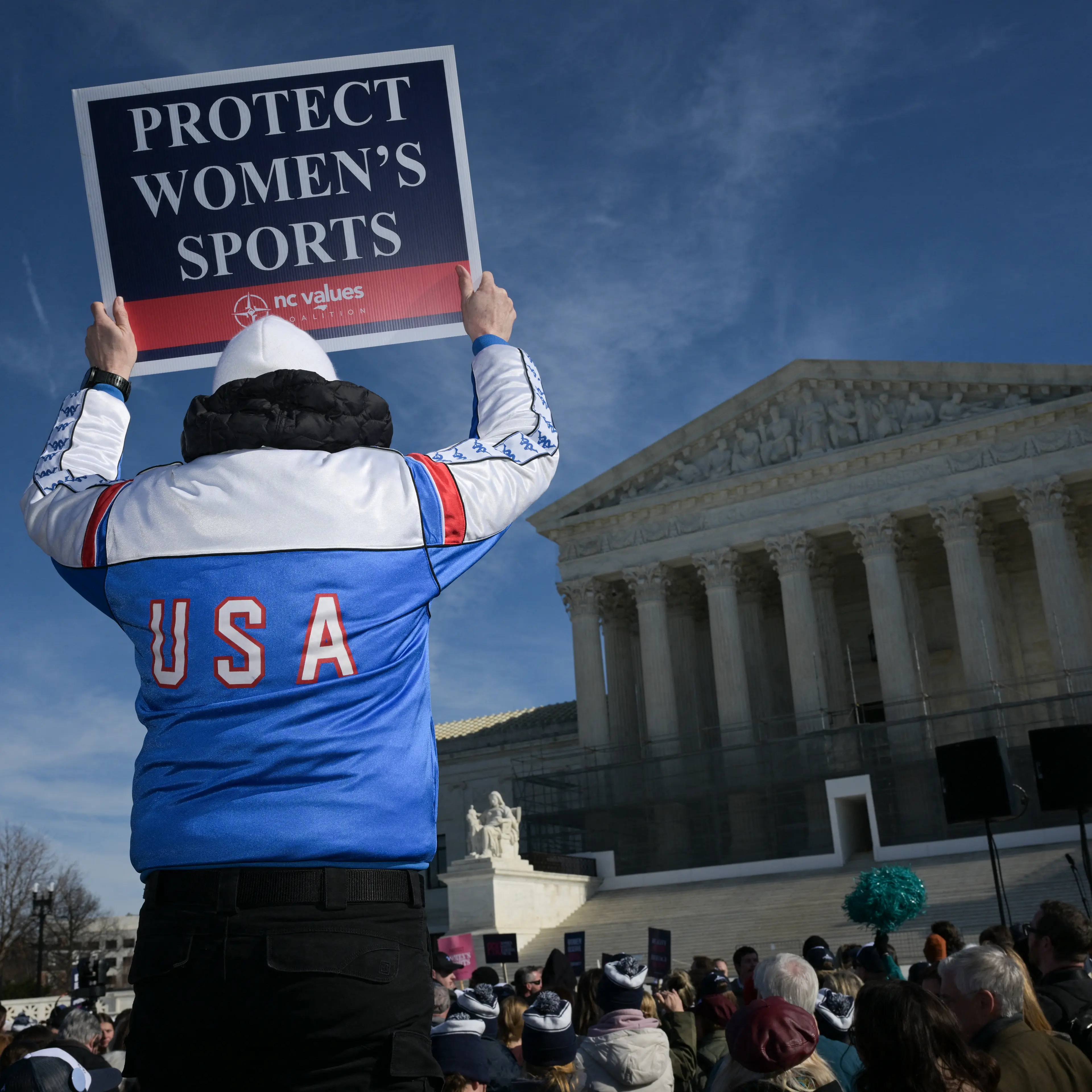 A man holds up a sign reading "Protect Women's Sports" as he demonstrates outside the U.S. Supreme Court as justices hear arguments in challenges to state bans on transgender athletes in women's sports on Jan. 13, 2026, in Washington, D.C.