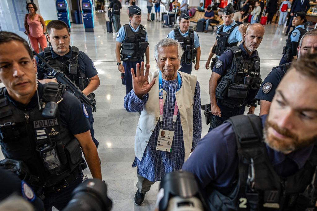 Bangladesh's finance pioneer Muhammad Yunus (C) is escorted by French police personnel as he arrives at Roissy-Charles de Gaulle Airport, north of Paris on August 7, 2024, enroute to Bangladesh.