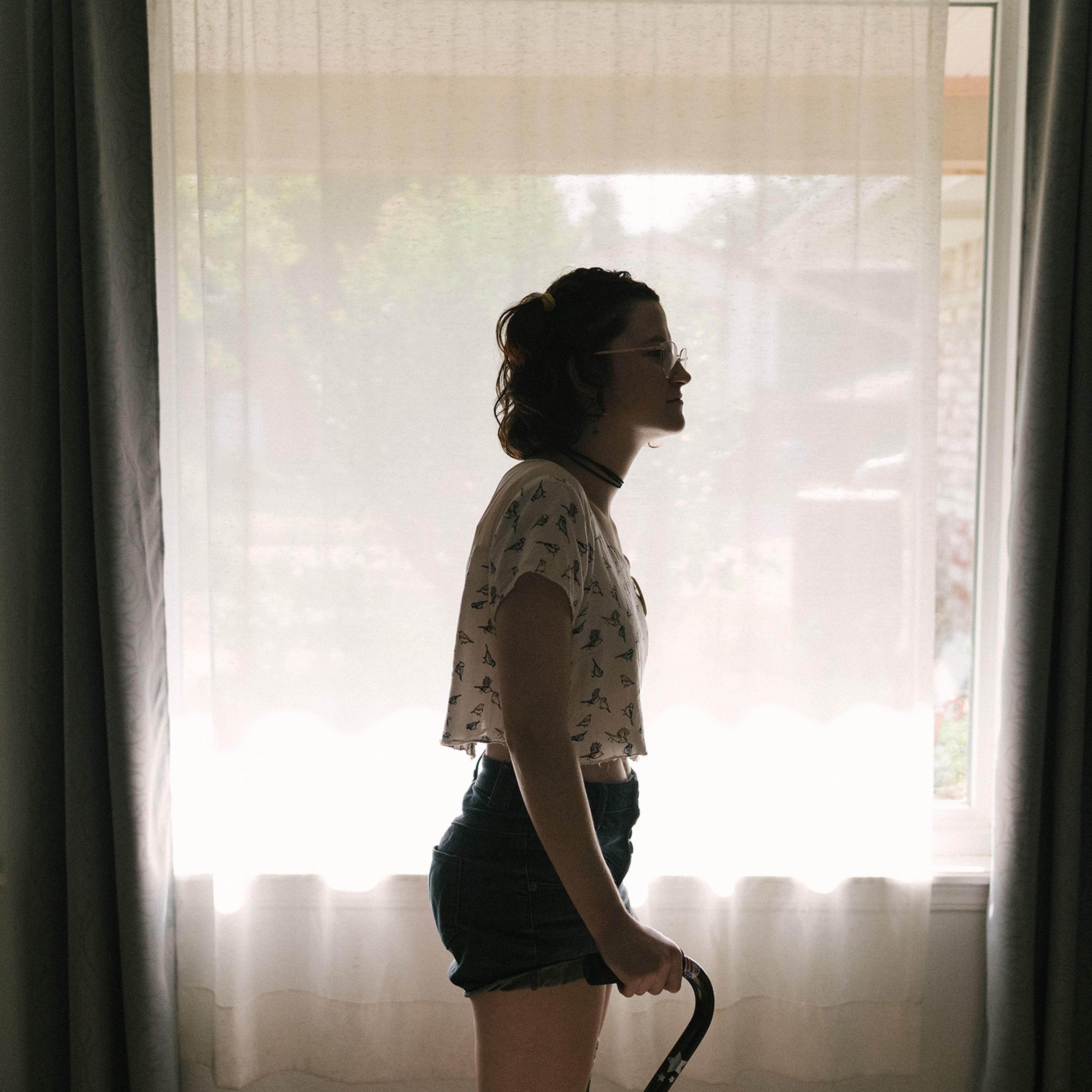 Flora Ellis in her living room in Norman, Okla., on July 19, 2022. Ellis has a connective-tissue disorder called Ehlers-Danlos syndrome, which prevents her body from properly making collagen.