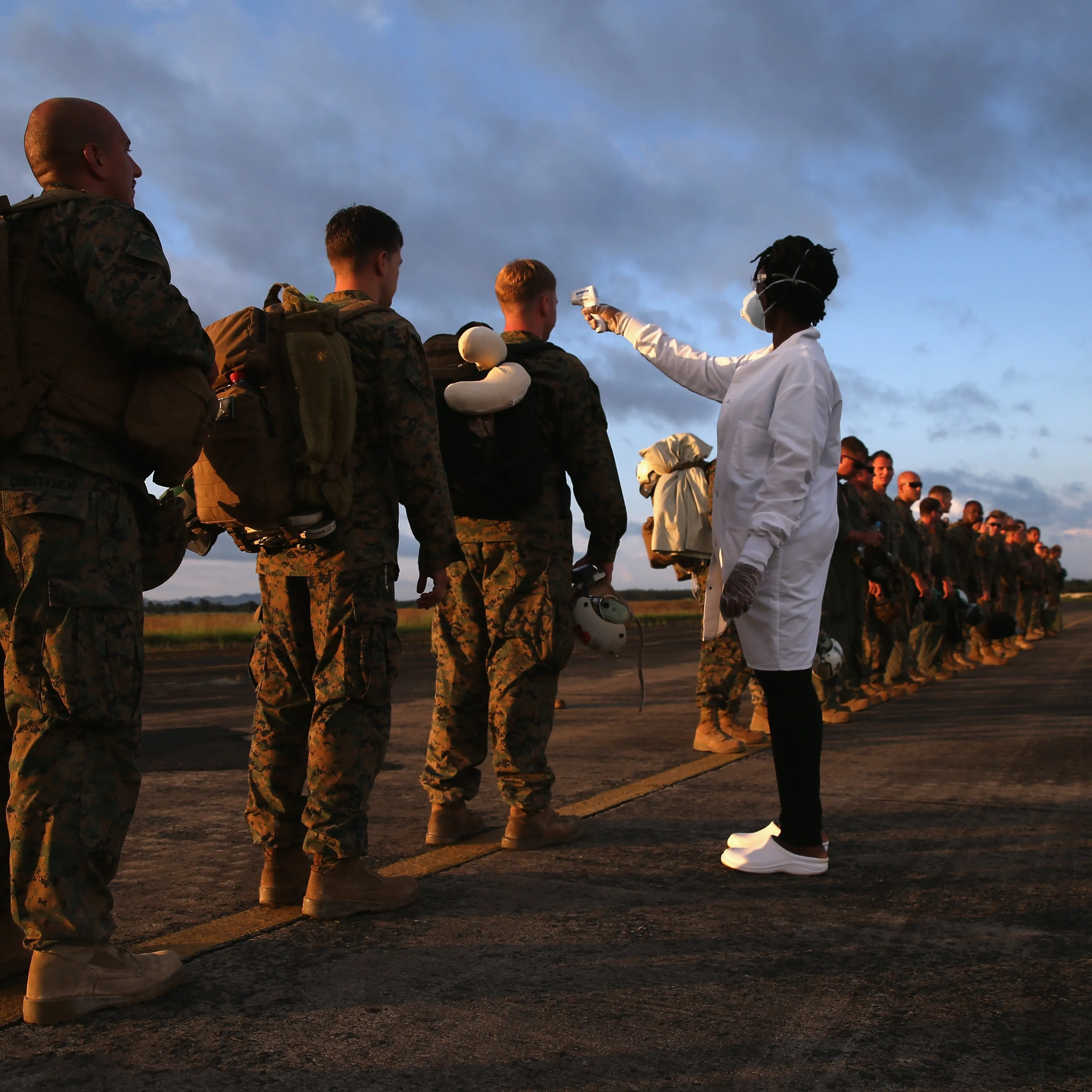 A health worker takes the temperature of U.S. Marines arriving to take part in Operation United Assistance on Oct. 9, 2014 near Monrovia, Liberia.