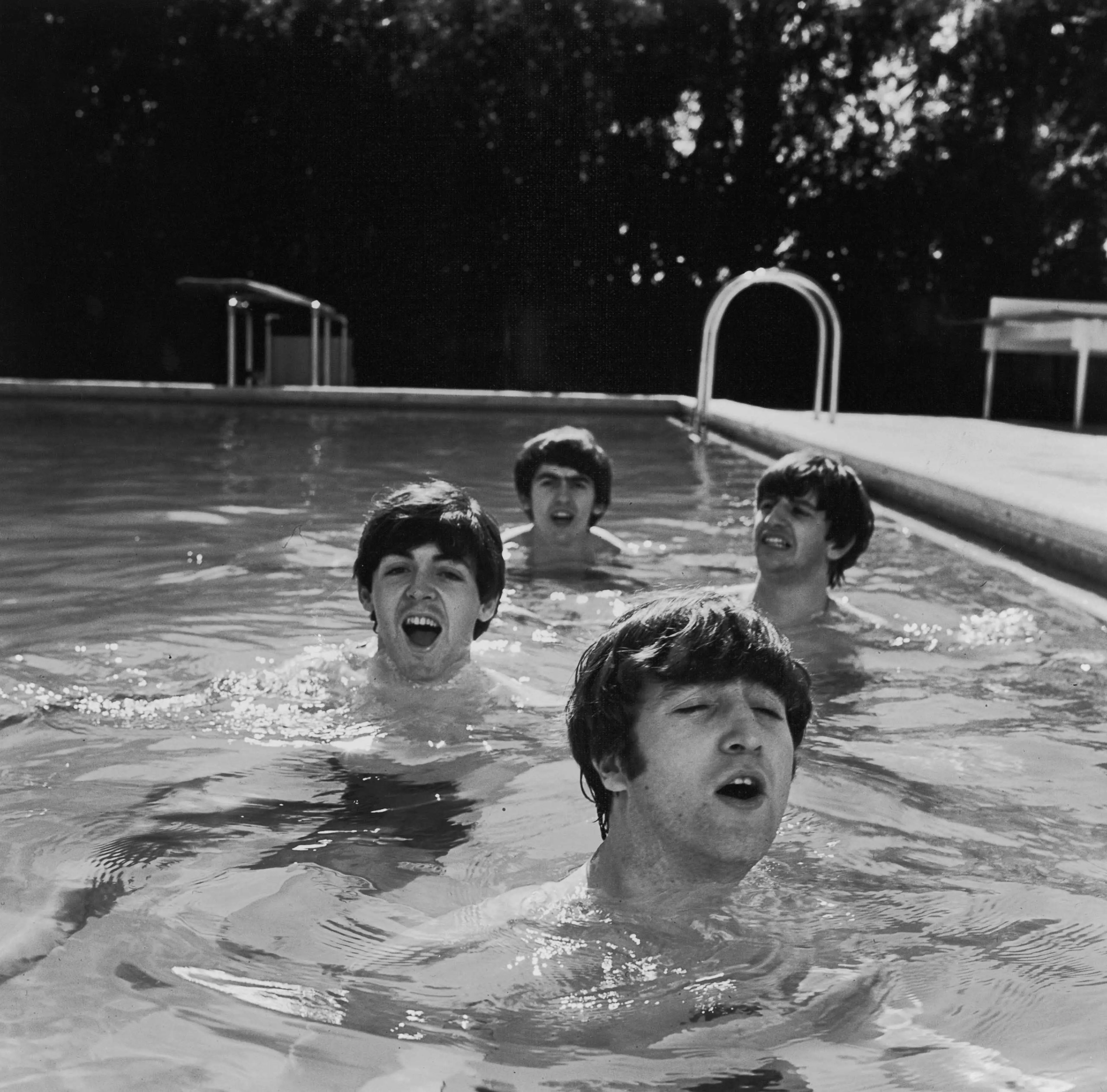 Four lads from Liverpool — Paul McCartney, George Harrison, John Lennon, and Ringo Starr — take a dip in an unheated Miami Beach swimming pool during a cold snap on their first trip to the States. "We could not find a heated pool that could be closed off