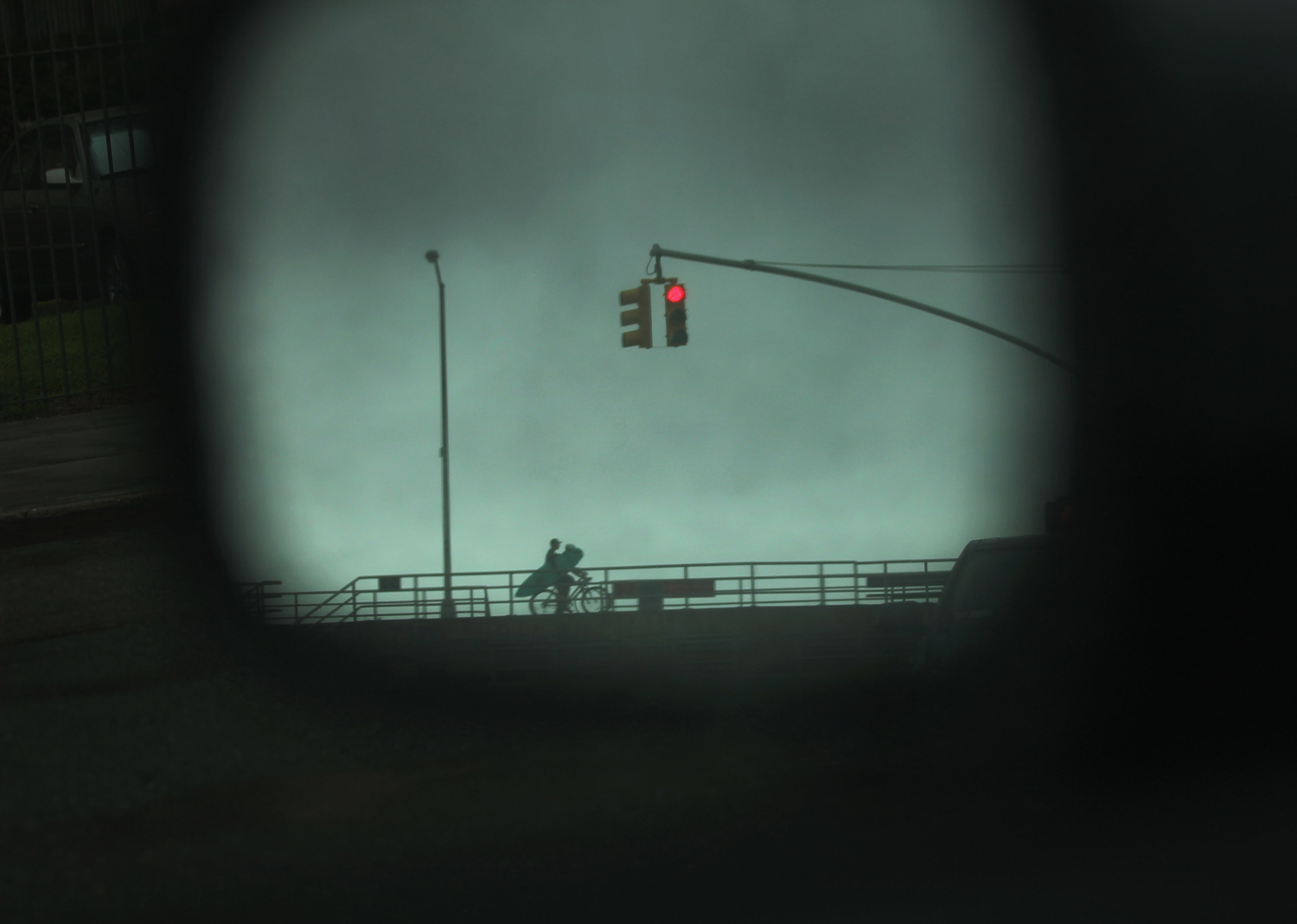 August 27, 2011, New York, NY. A surfer is viewed on his bike through a car mirror in the Rockaways before the arrival of Hurricane Irene. The Rockaways were under mandatory evacuation orders. 
