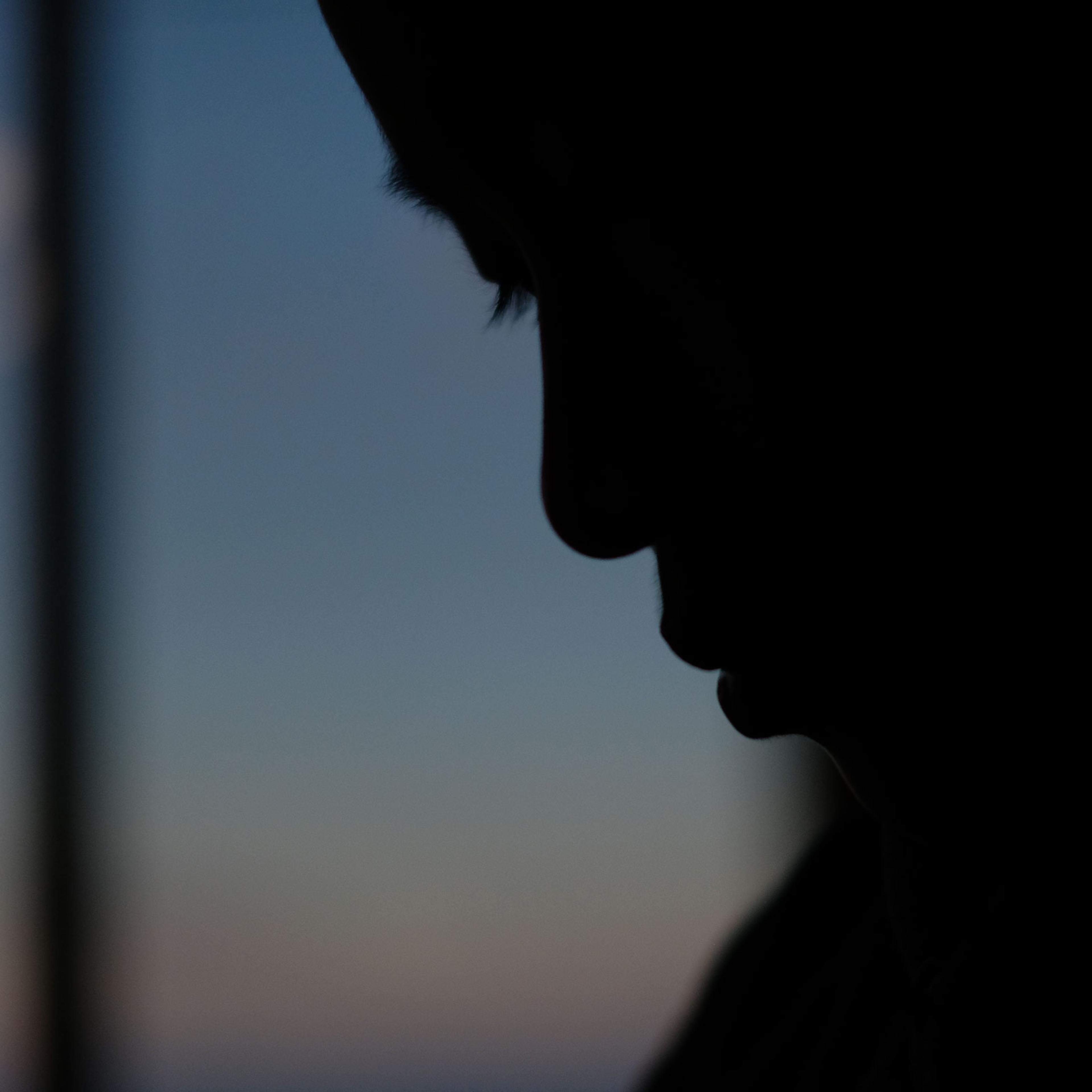 A silhouette of a child's face
