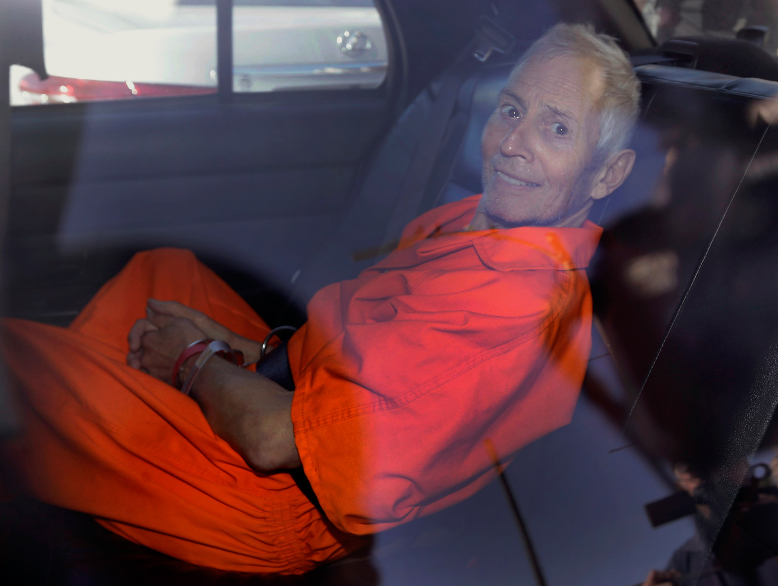 FILE - In this Tuesday, March 17, 2015, file photo, Robert Durst is transported from Orleans Parish Criminal District Court to the Orleans Parish Prison after his arraignment in New Orleans. The whispered words of Durst recorded in an unguarded moment in