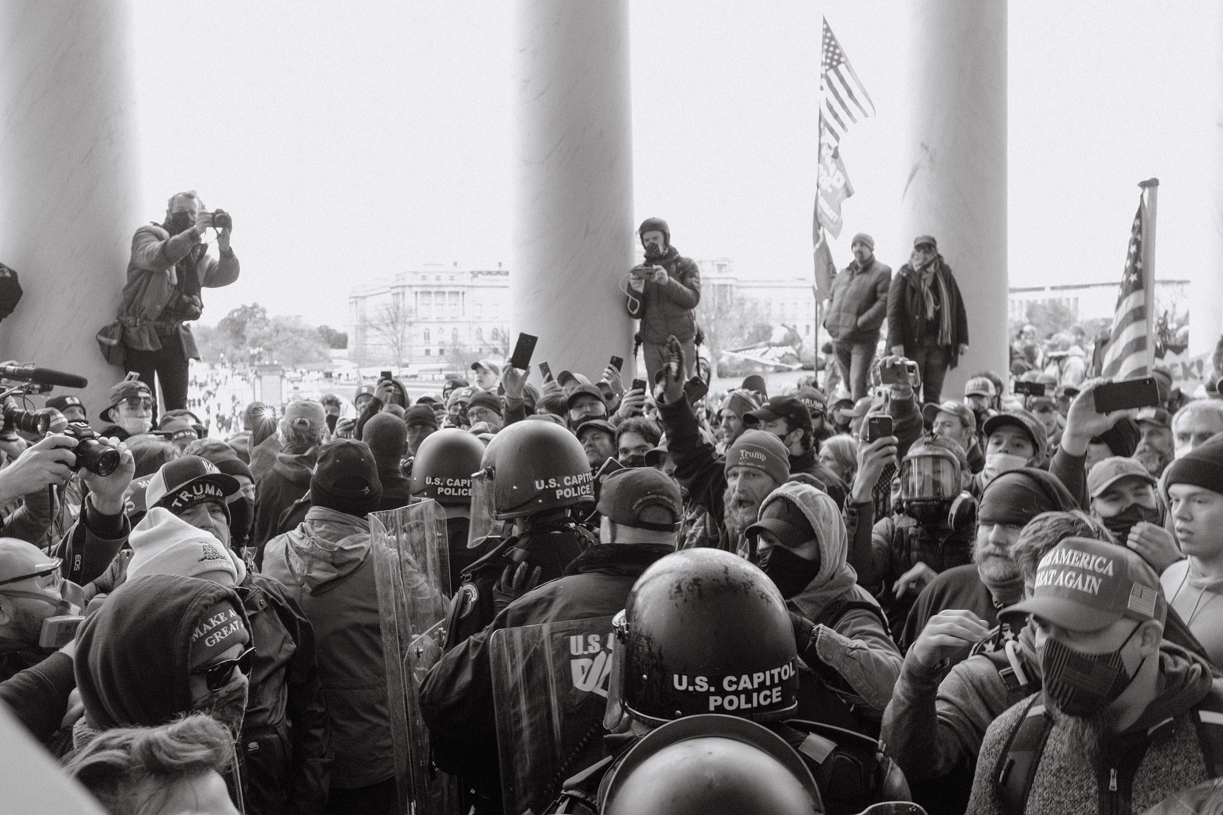 Capitol police walk through a crowd of Trump supporters outside of the Capitol.