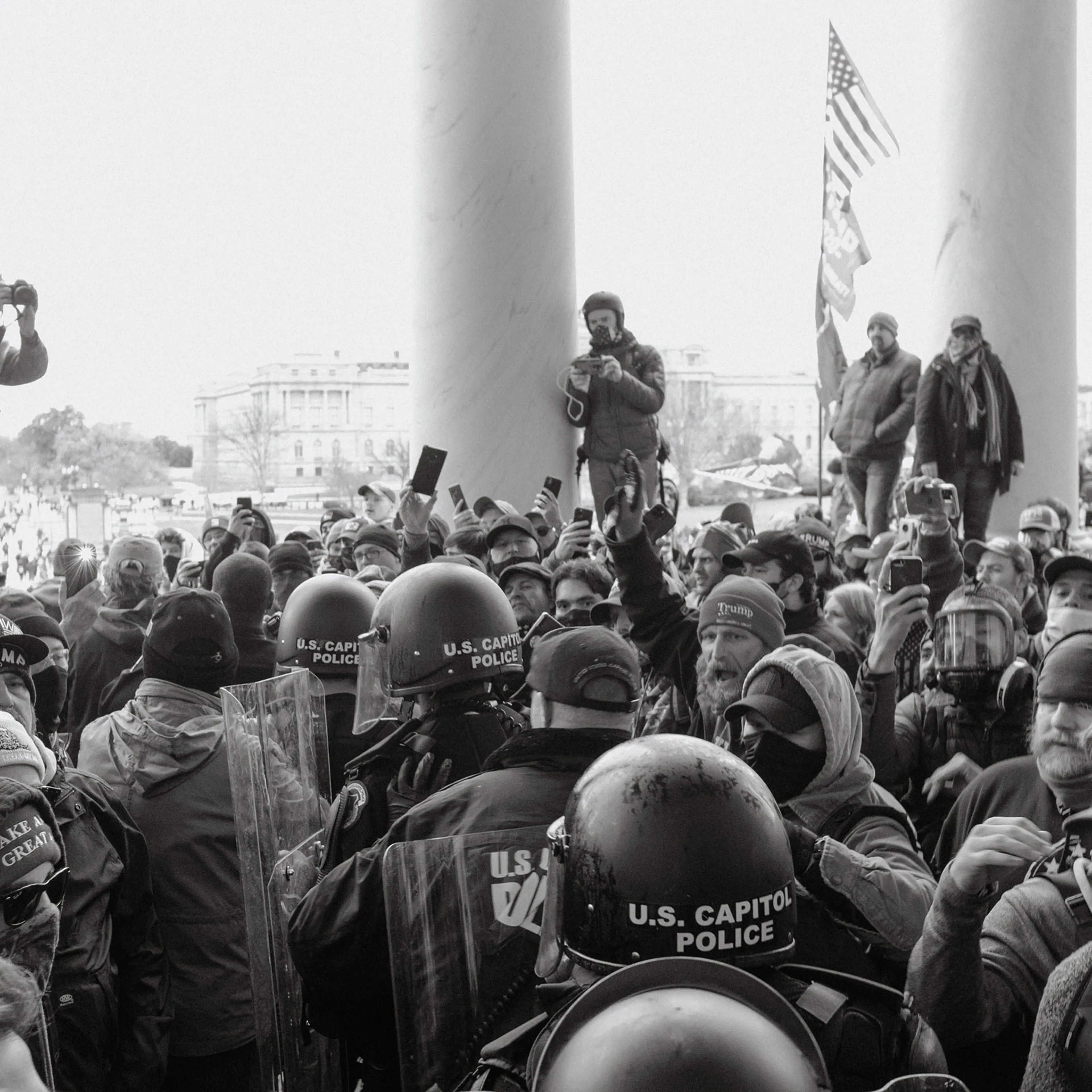 Capitol police walk through a crowd of Trump supporters outside of the Capitol.