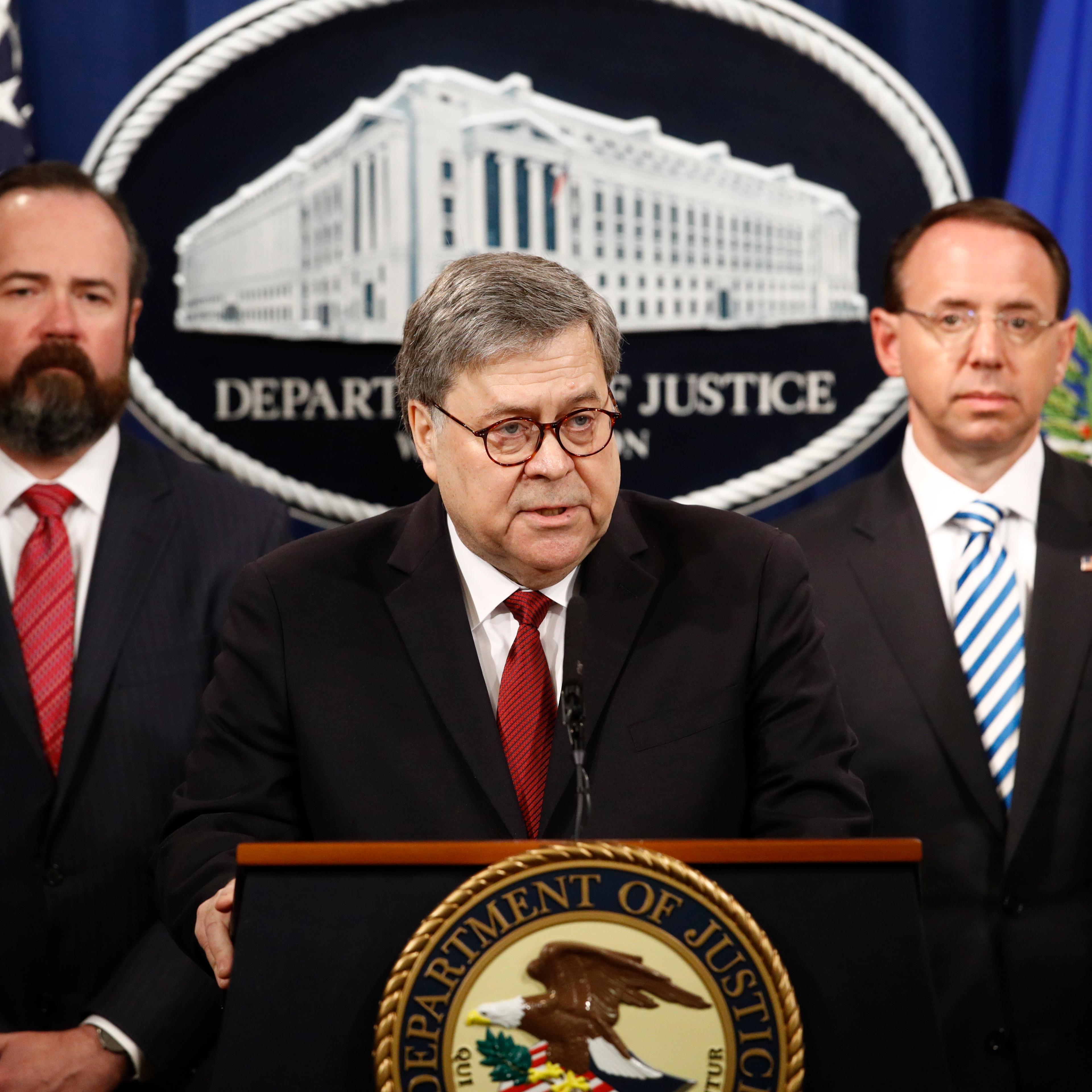 Attorney General William Barr speaks alongside Deputy Attorney General Rod Rosenstein, right and Deputy Attorney General Ed O'Callaghan, left, about the release of a redacted version of special counsel Robert Mueller's report during a news conference, Th