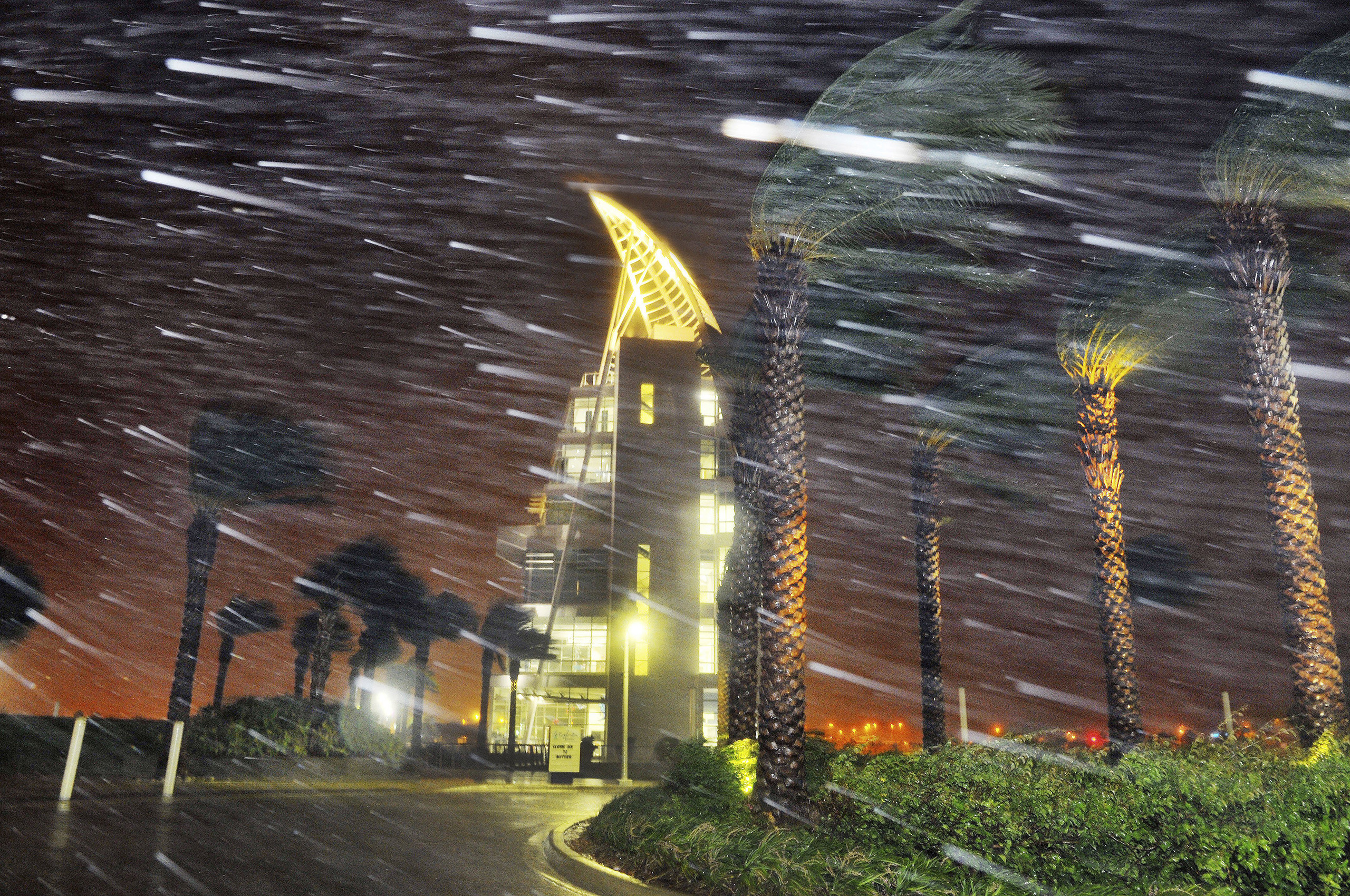 Trees sway from heavy rain and wind from Hurricane Matthew in front of Exploration Tower in Cape Canaveral, Fla., Oct. 7, 2016.