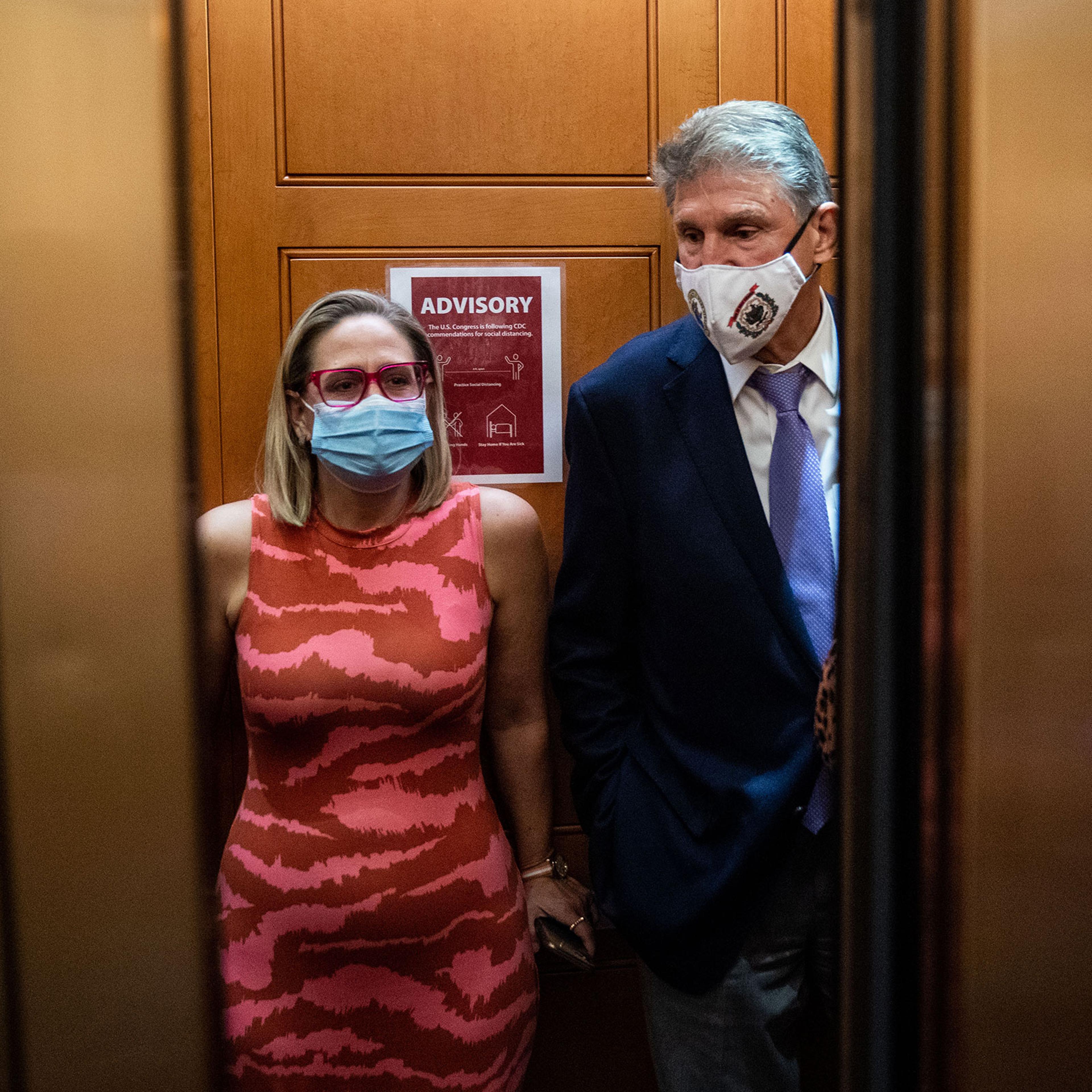 Sen. Kyrsten Sinema and Sen. Joe Manchin in the elevator on their way to go to the Senate Chamber on Sept. 30, 2021 on Capitol Hill in Washington.