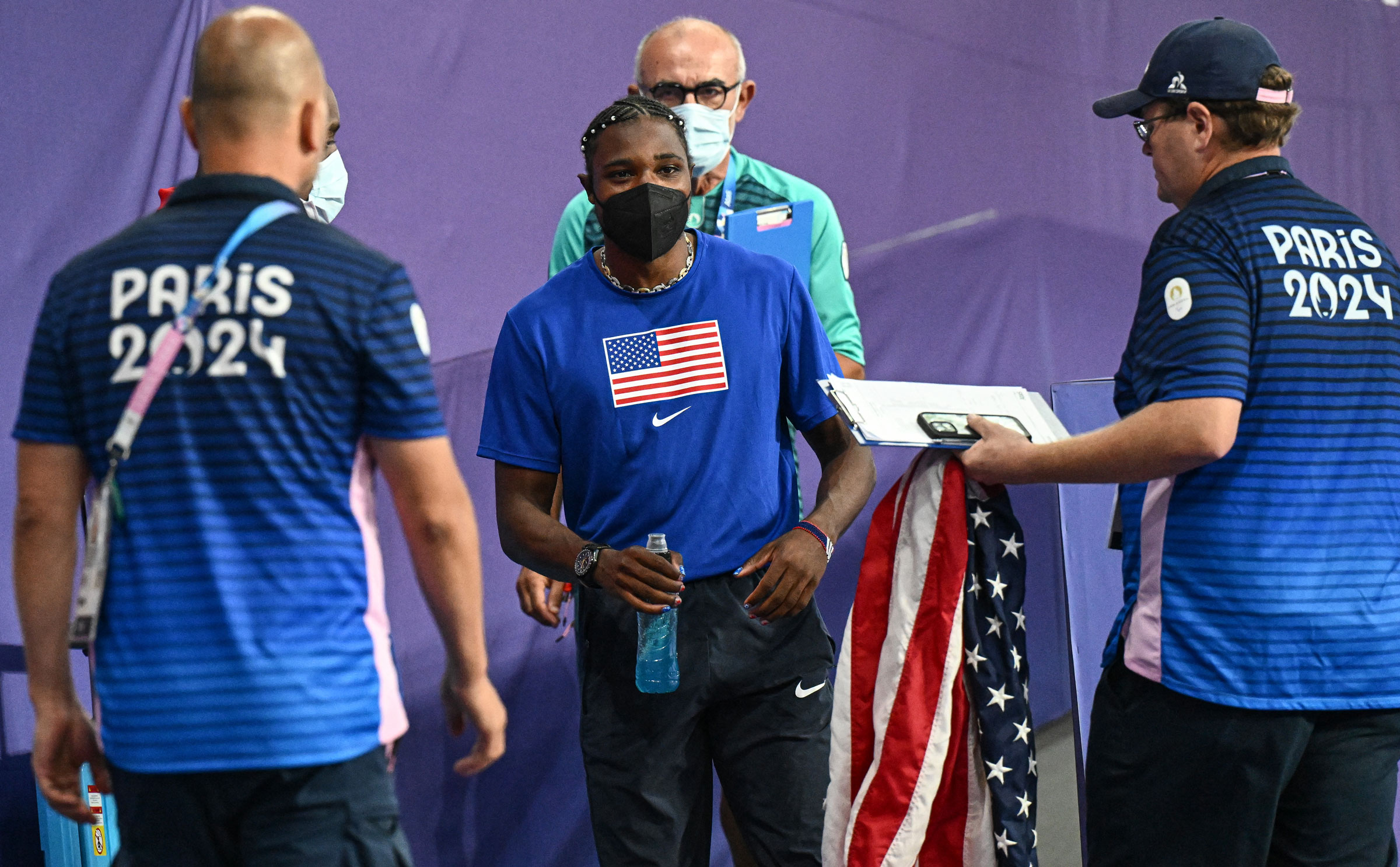 Noah Lyles, wearing a mask, leaves after the men’s 200m final at the Paris 2024 Olympic Games, on Aug. 8, 2024.