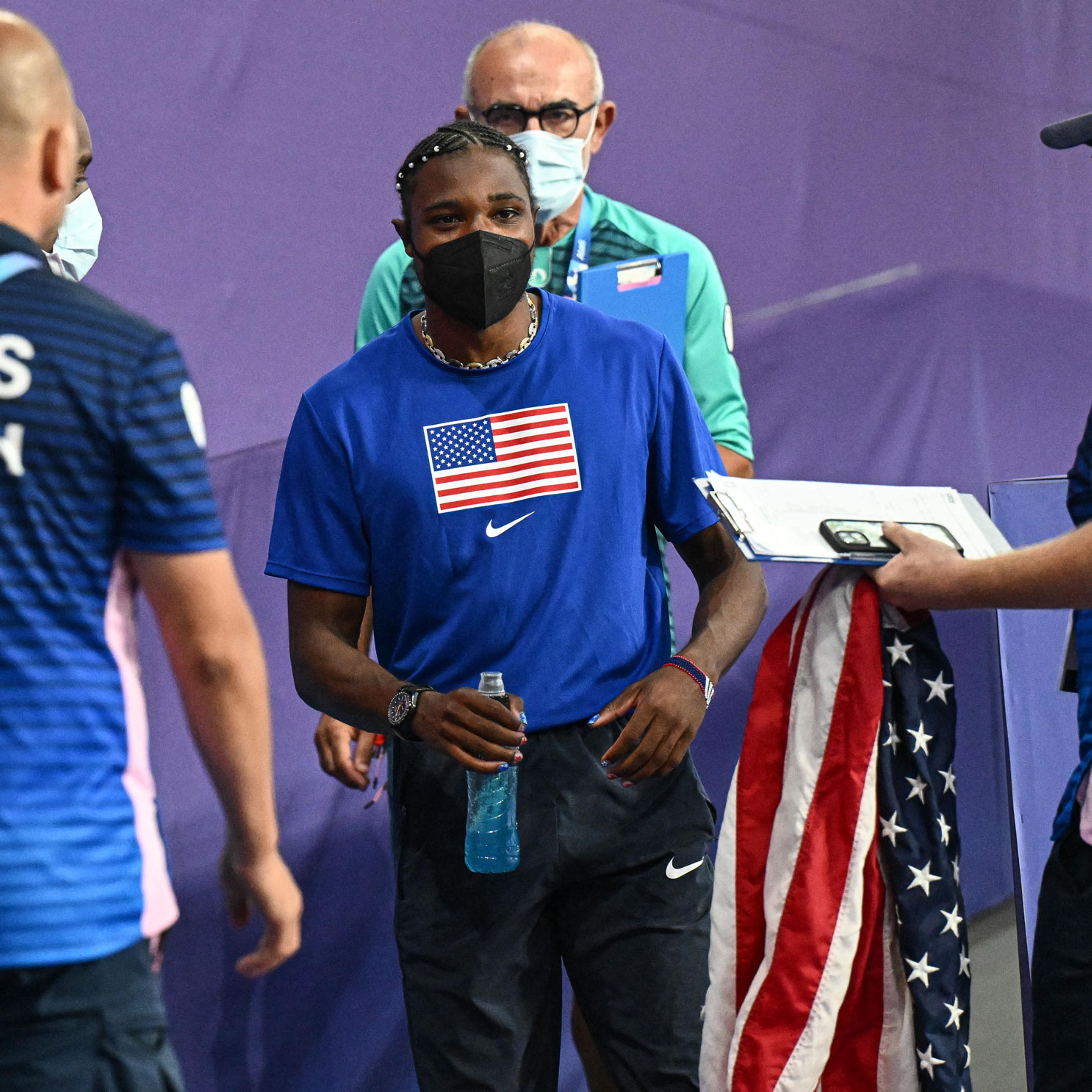 Noah Lyles, wearing a mask, leaves after the men’s 200m final at the Paris 2024 Olympic Games, on Aug. 8, 2024.