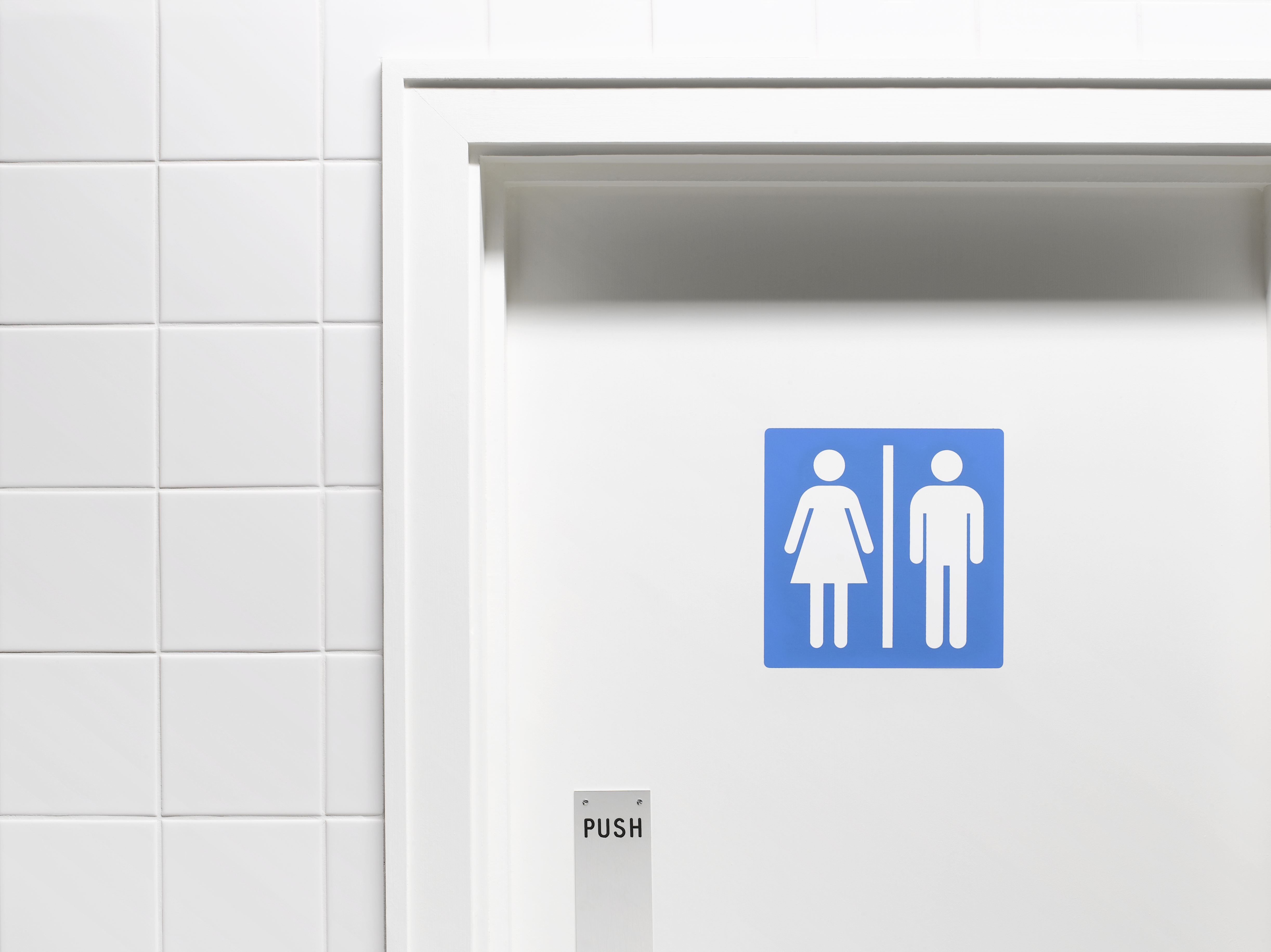 Female and male sign on toilet door, close-up