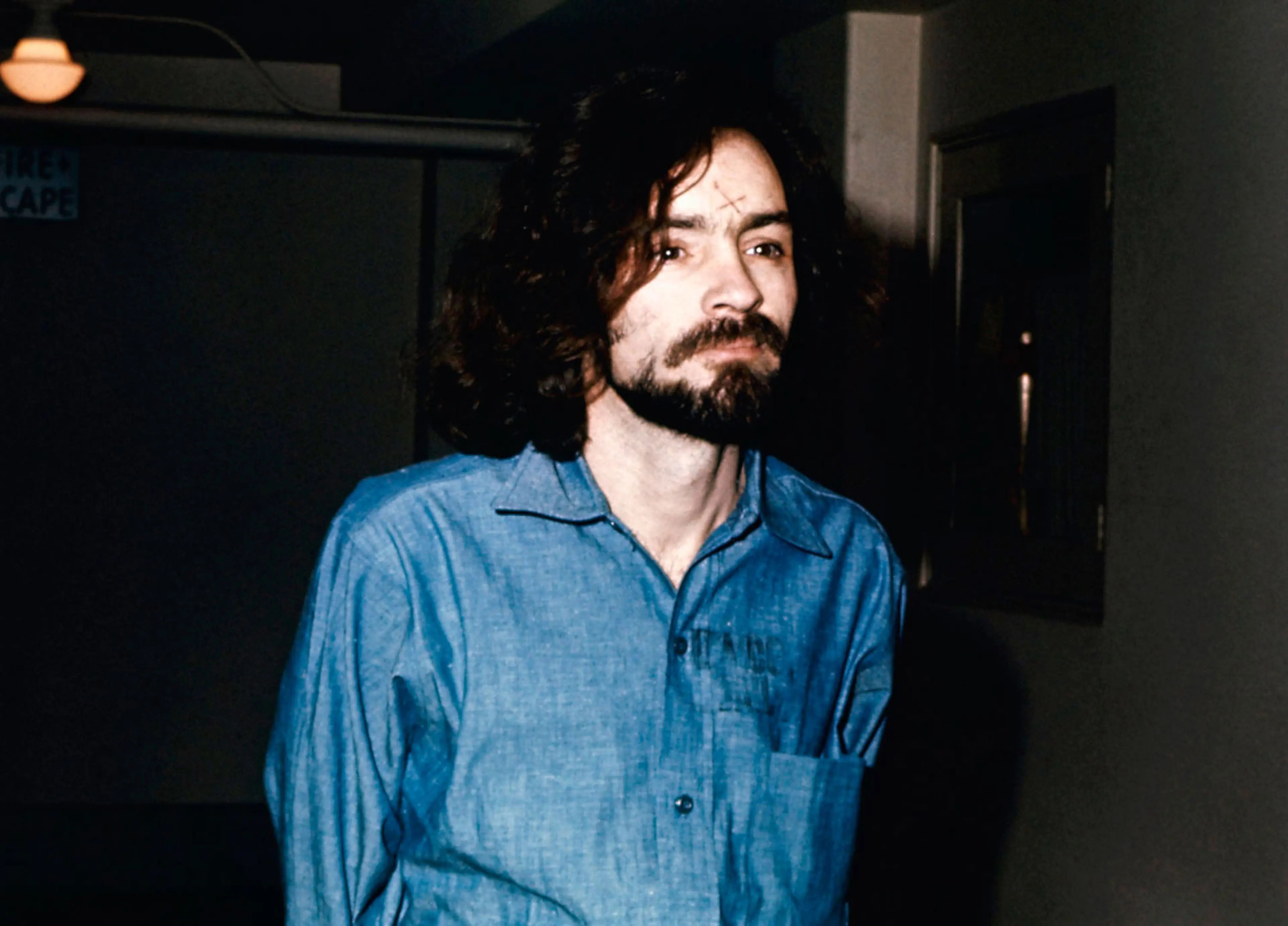 Charles Manson appears during his trial with an 'X' carved into his forehead, in 1970.