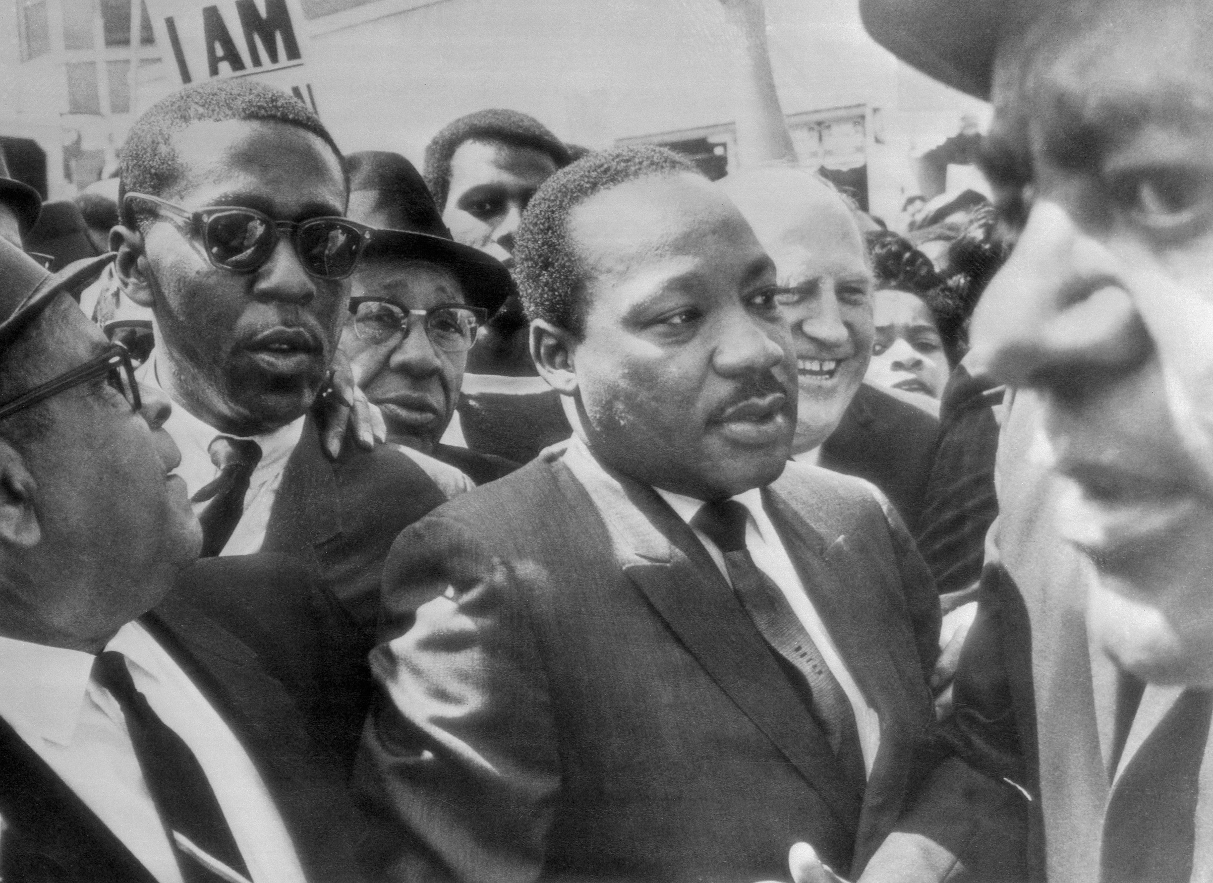 Dr. Martin Luther King (center) is surrounded by leaders of the sanitation strike, as he arrived to lead a march in support of the striking workers on Mar. 28, 1968.