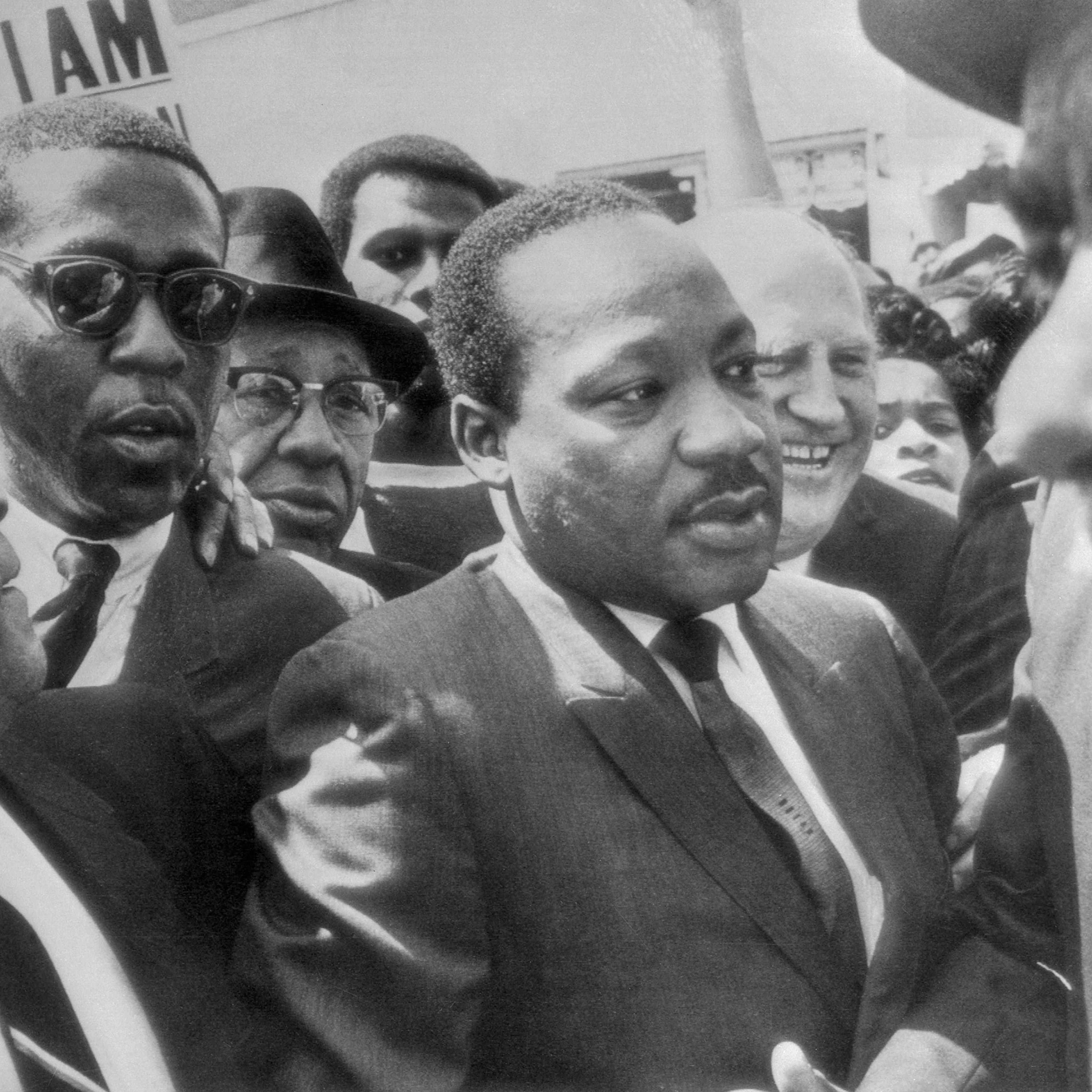 Dr. Martin Luther King (center) is surrounded by leaders of the sanitation strike, as he arrived to lead a march in support of the striking workers on Mar. 28, 1968.