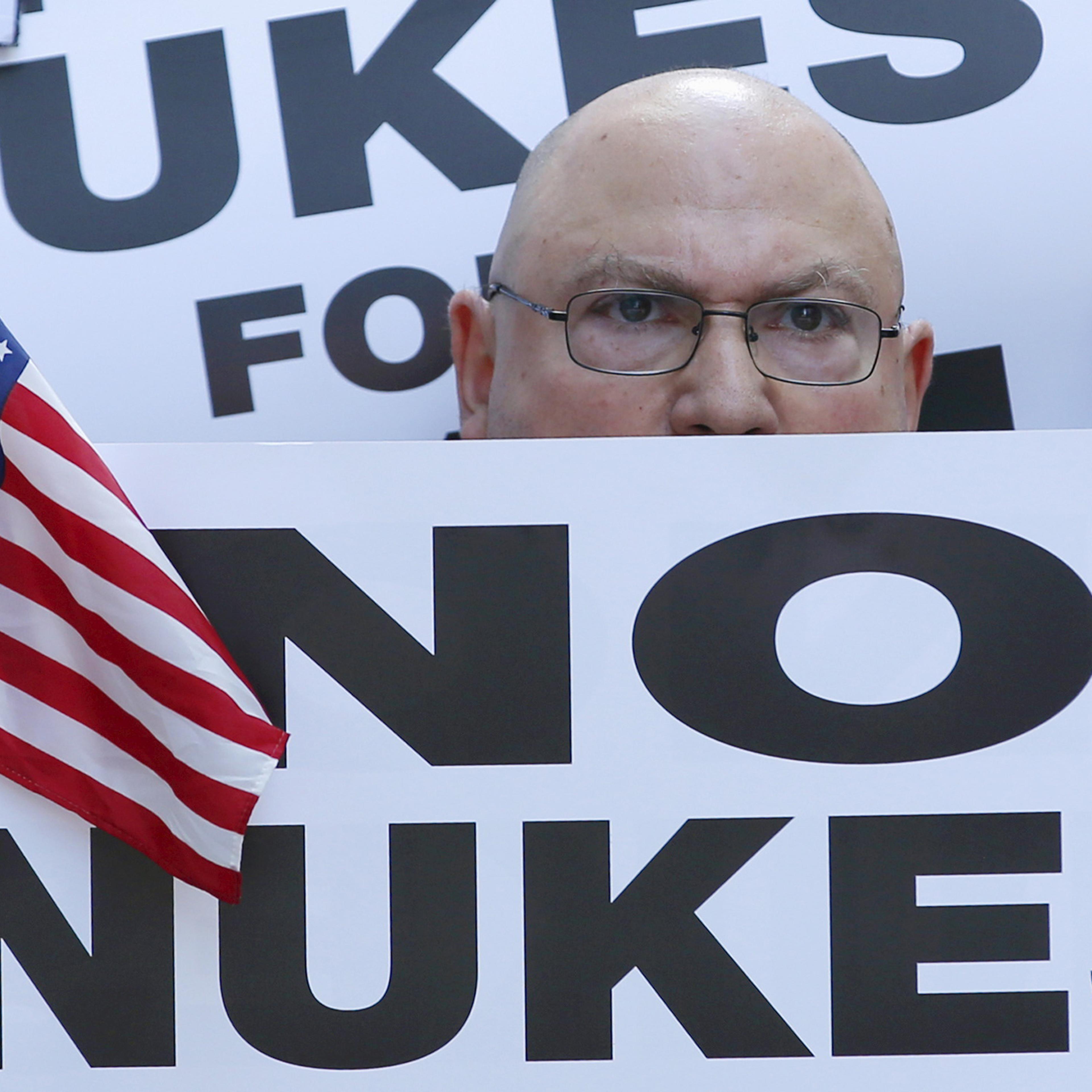 A man holds up a sign as he and several thousand other protestors demonstrate during a rally apposing the nuclear deal with Iran in Times Square in the Manhattan borough of New York City on July 22, 2015.