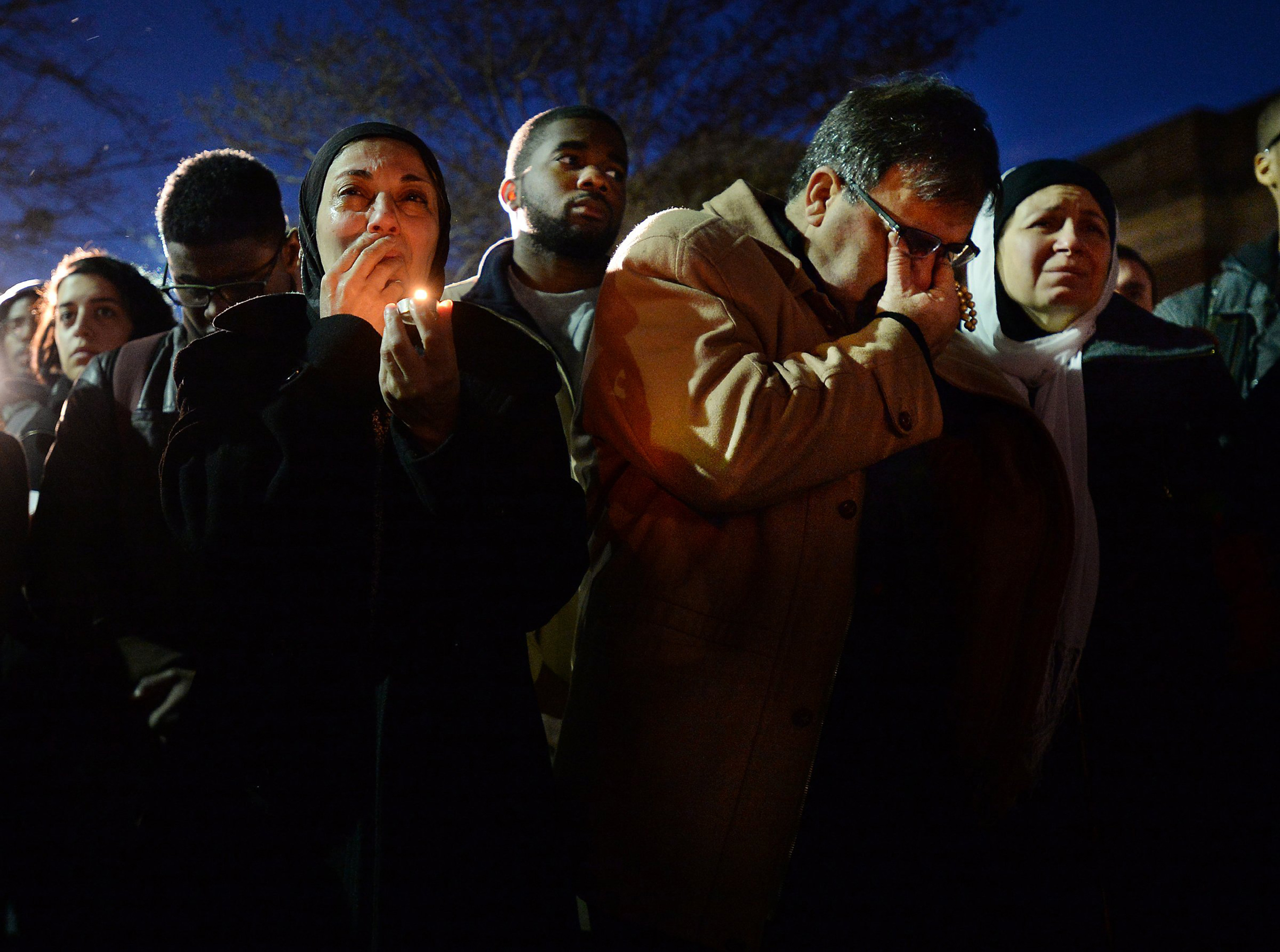Namee Barakat (center) and his wife Layla (right) break into tears while watching a photo presentation during a vigil for his daughters on Feb. 11, 2015, in Chapel Hill, N.C.