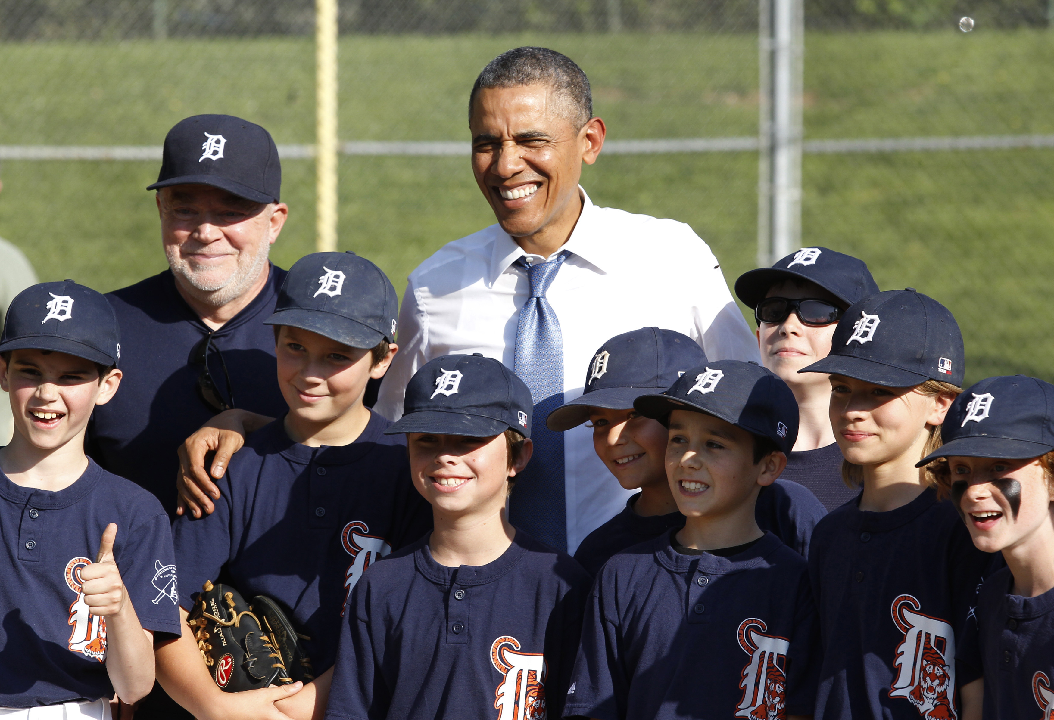 U.S. President Barack Obama poses with Little League baseball players and their coach at Friendship Park in Washington