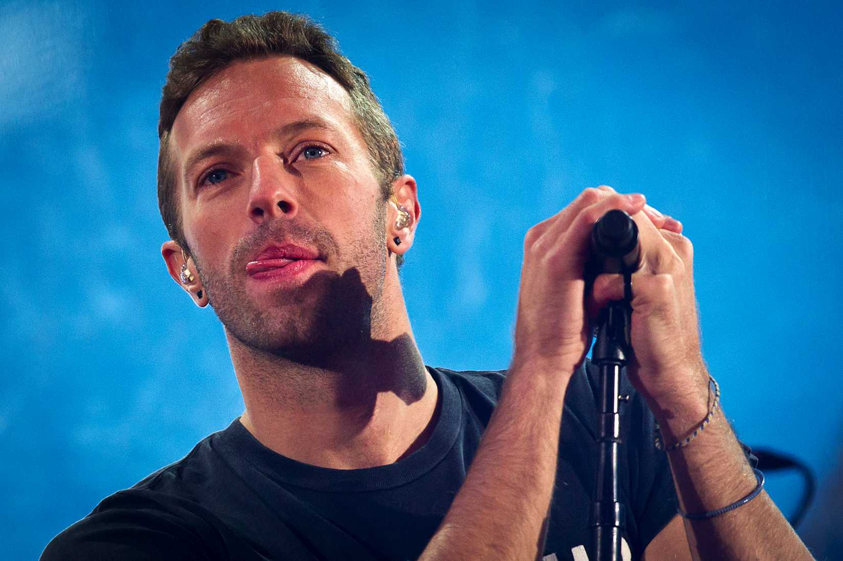 Chris Martin performs with U2 during a surprise concert in support of World AIDS Day in Times Square in New York City on Dec. 1, 2014 