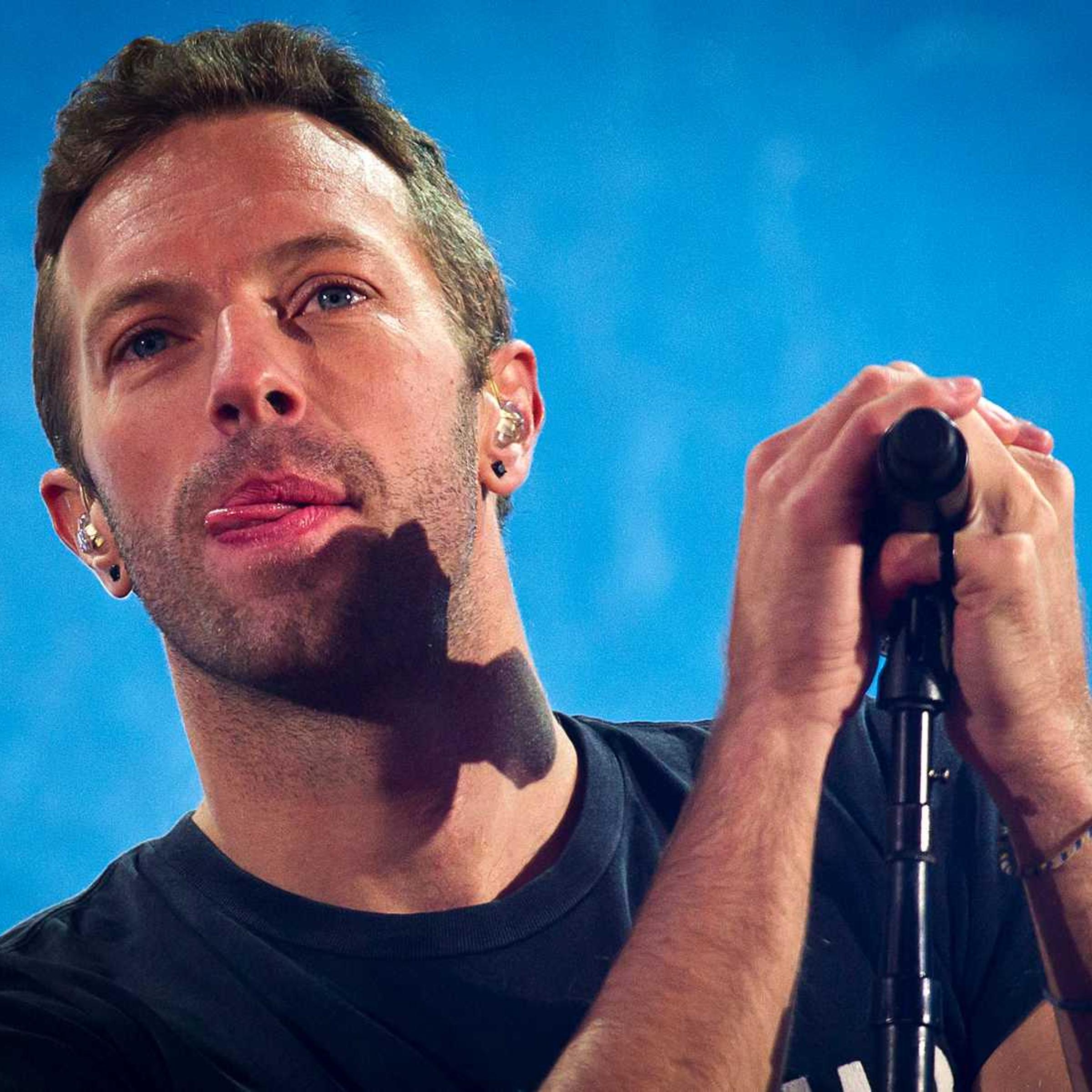 Chris Martin performs with U2 during a surprise concert in support of World AIDS Day in Times Square in New York City on Dec. 1, 2014