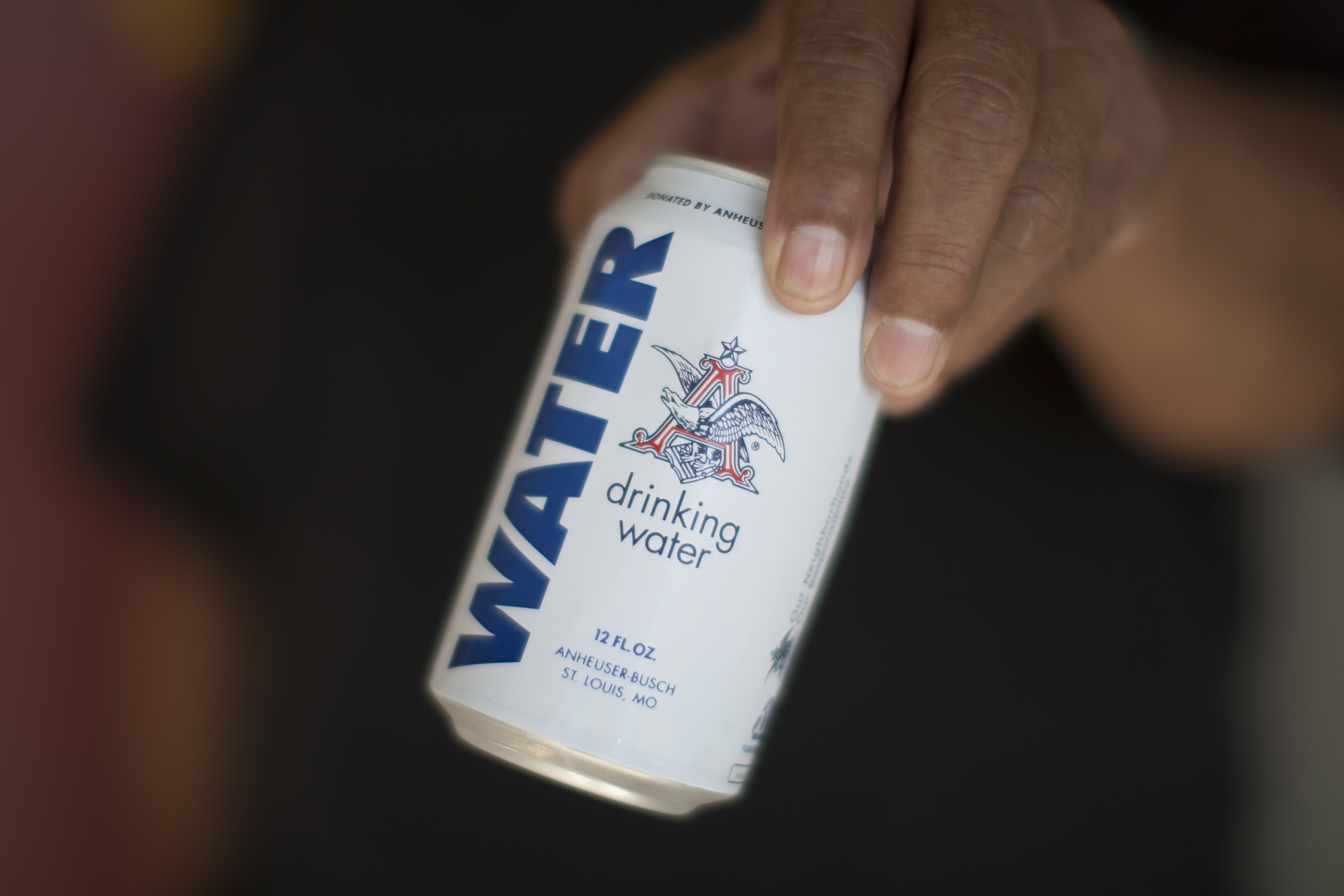 A resident holds a can of water donated by the Anheuser-Busch company as water wells supplying hundreds of residents remain dry in the fourth year of worsening drought on February 11, 2015 in East Porterville, California. 