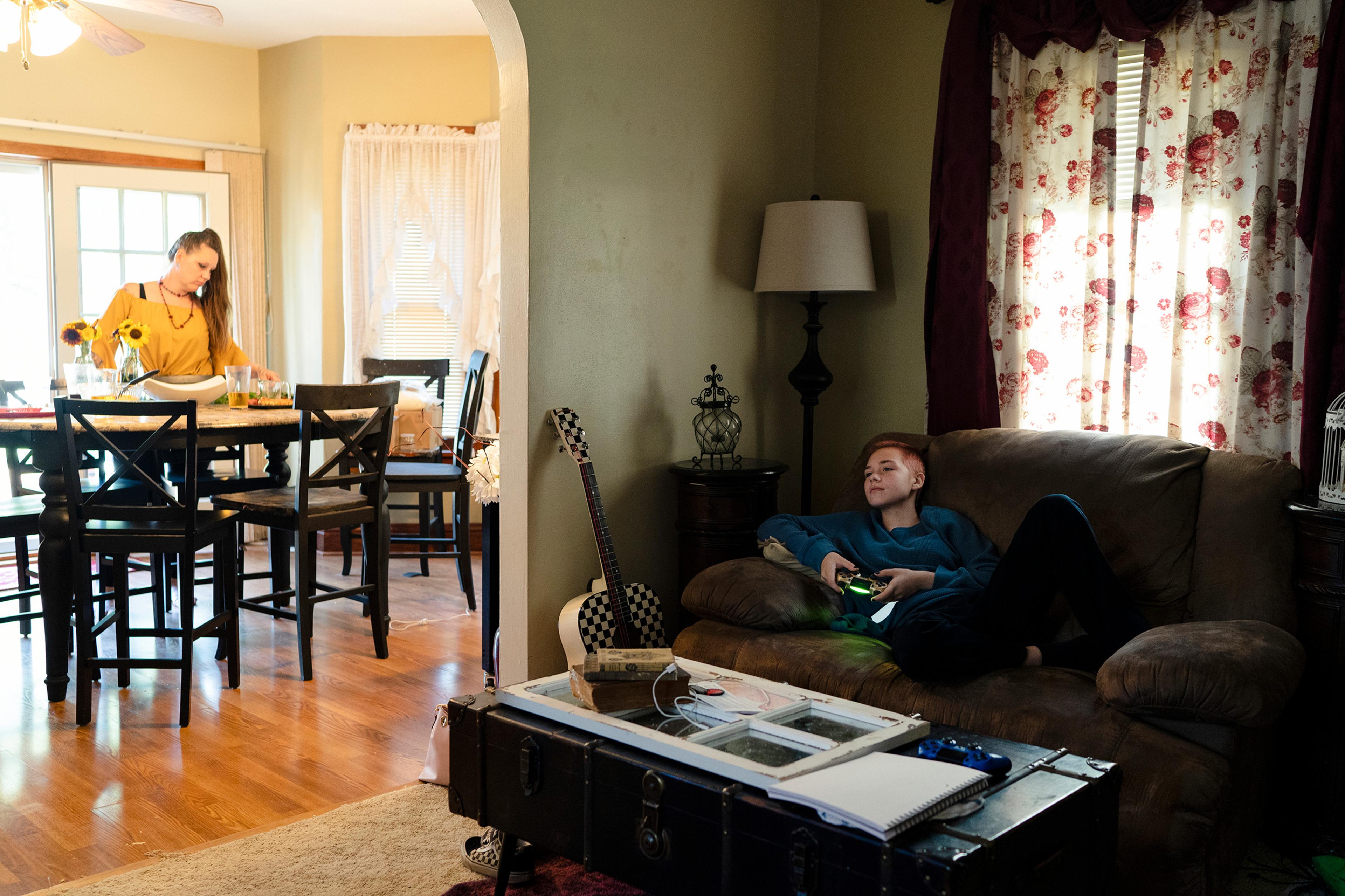 Ace, 12, plays video games in his home in Watertown, South Dakota. Ace says the past school year has been hard, and he can "barely walk down the hallway without getting made fun of." His sibling Aja is also gender expansive, and he says it’s been nice th