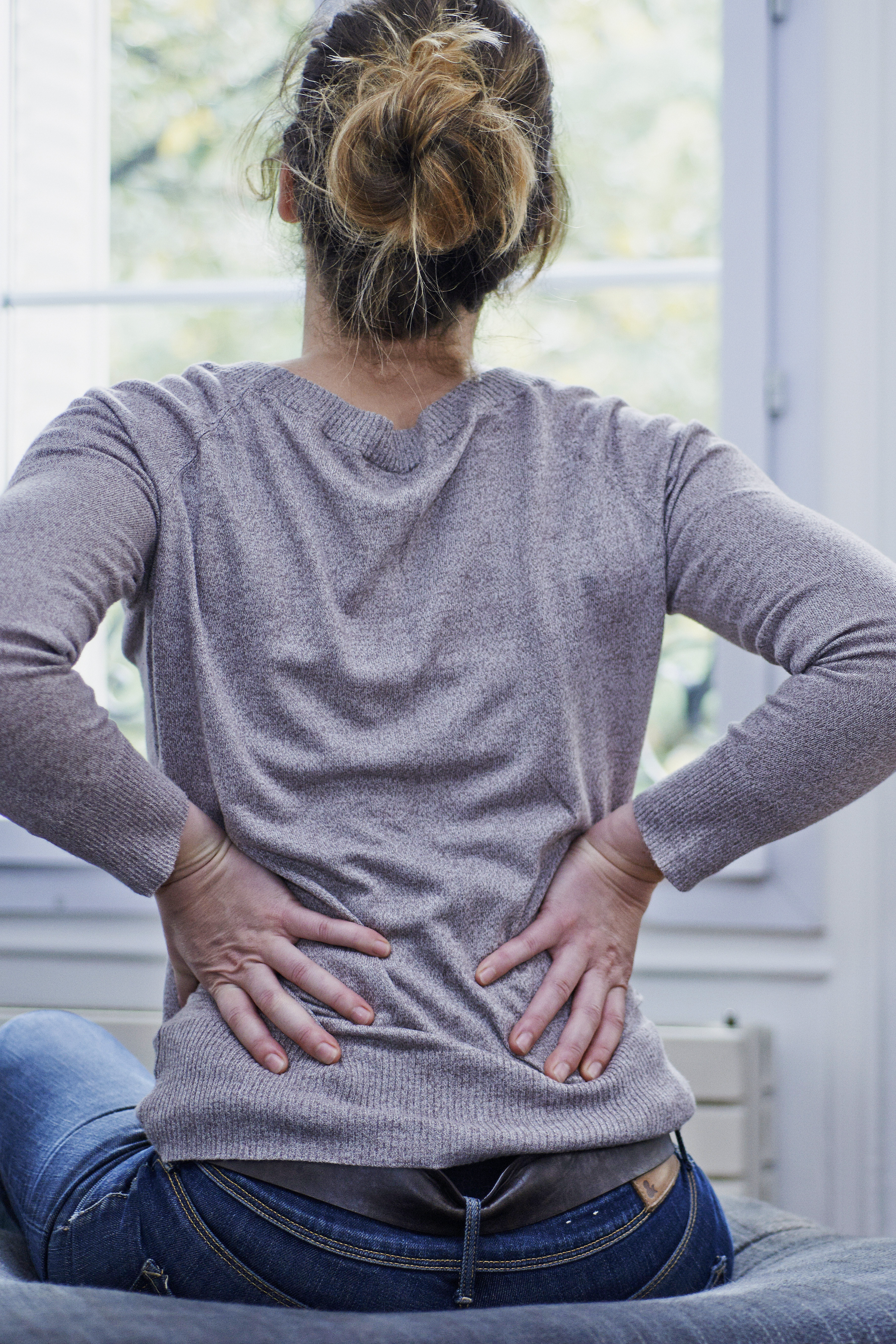 Woman suffering from lumbar pain.