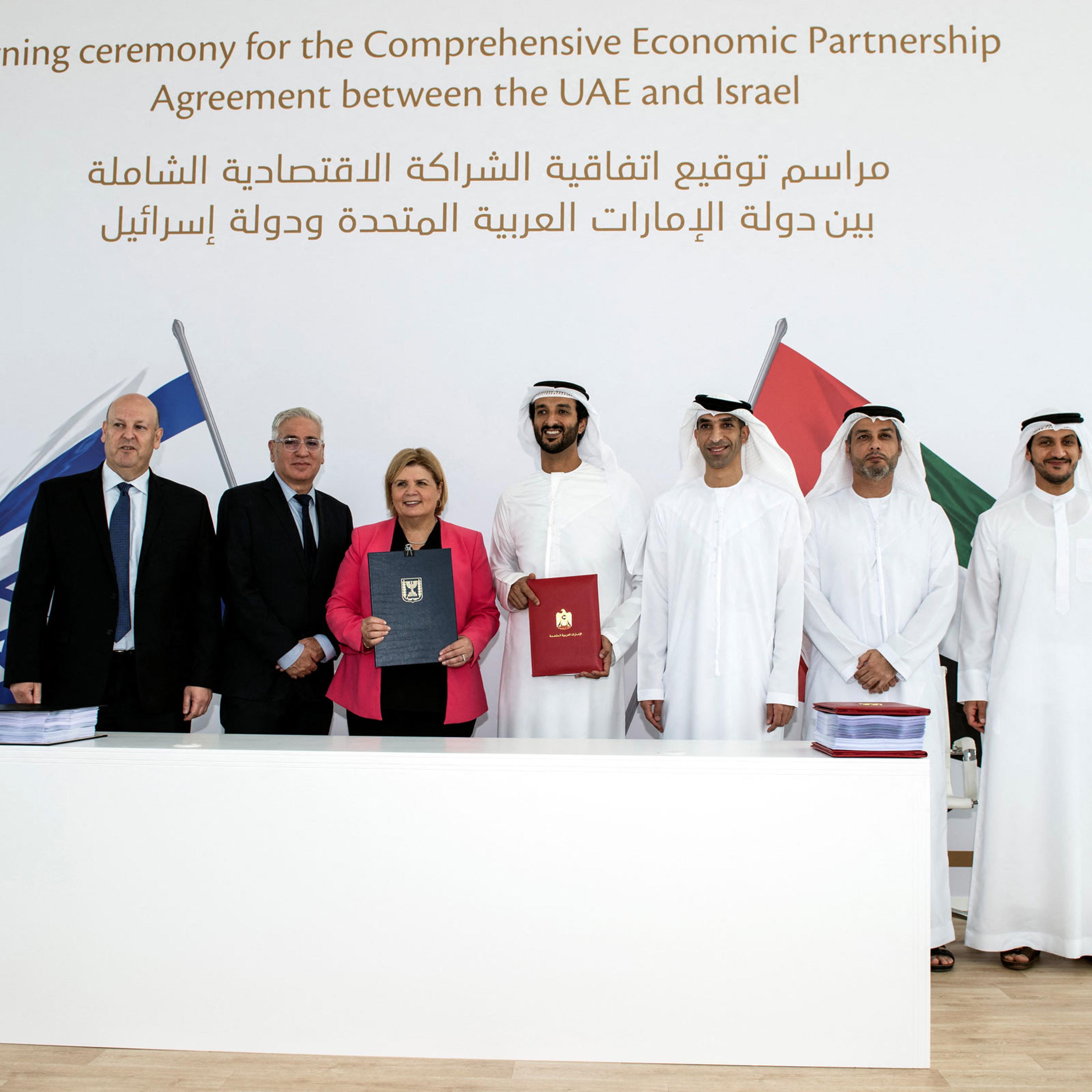 Israel's Minister of Economy and Industry Orna Barbivai, UAE Minister of Economy Abdulla bin Touq Al Marri and other officials present the Free Trade Agreement they signed