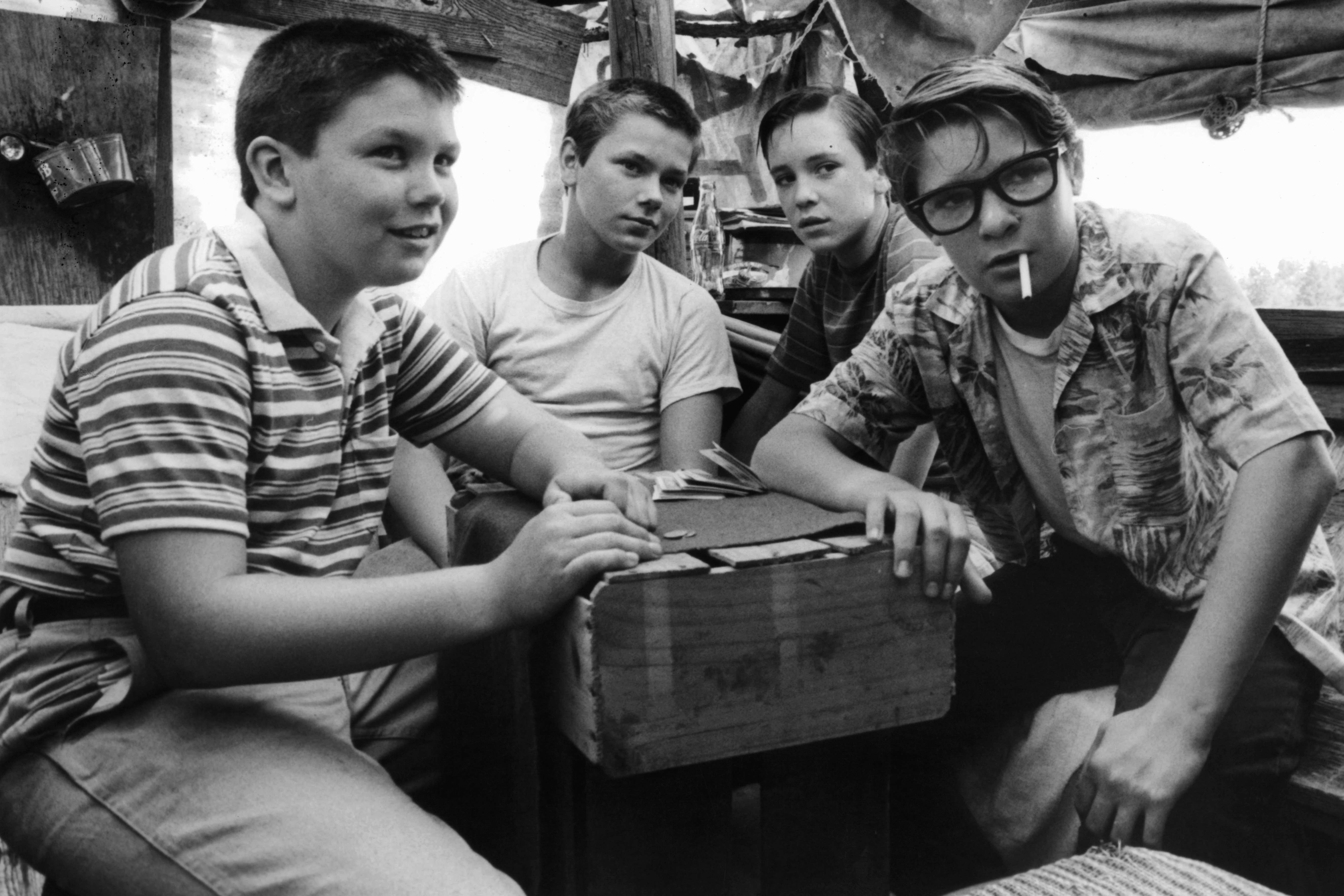 (from L-R) Jerry O'Connell, River Phoenix, Wil Wheaton, and Corey Feldman are gathered around together in a scene from the film <i>Stand By Me</i> (1986).