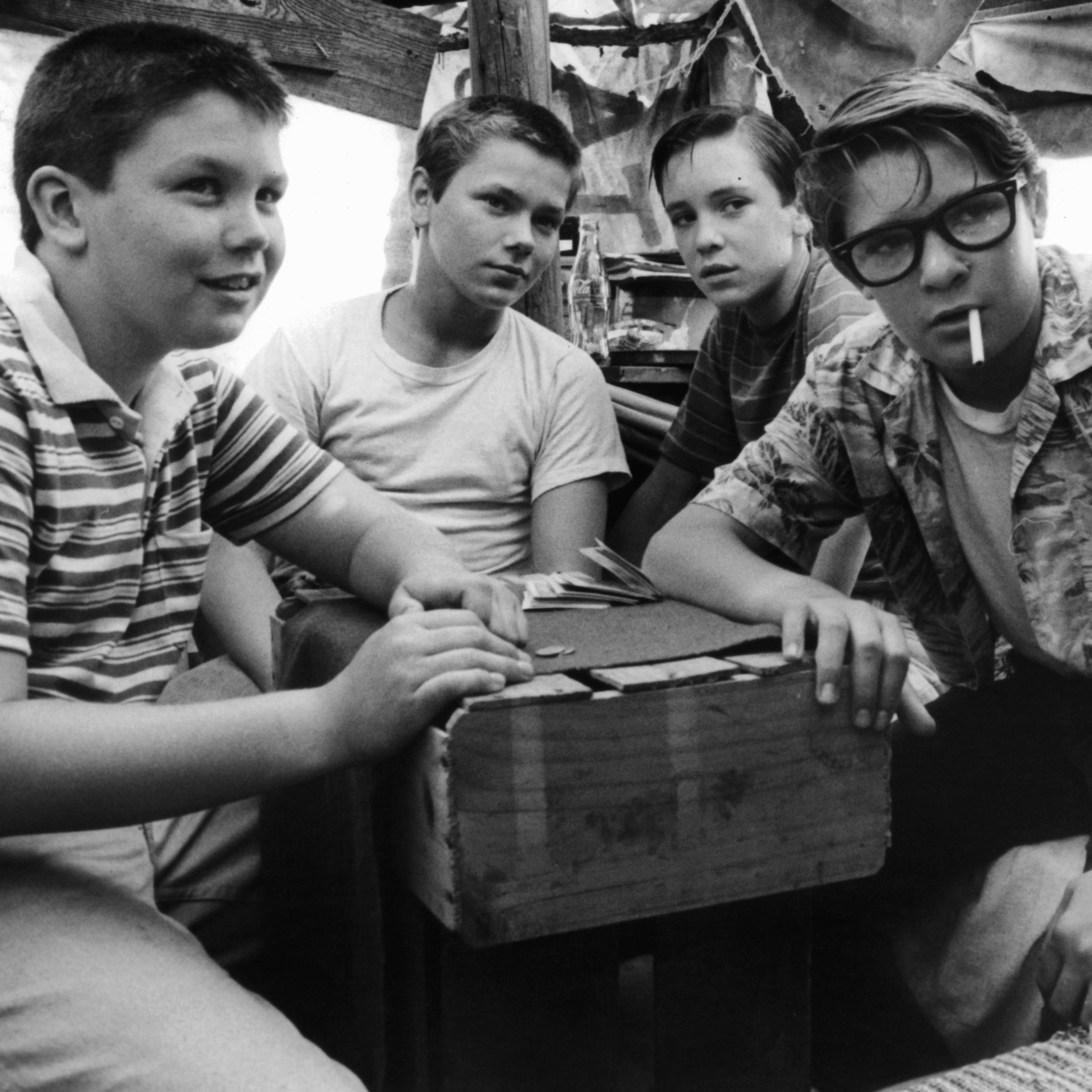 (from L-R) Jerry O'Connell, River Phoenix, Wil Wheaton, and Corey Feldman are gathered around together in a scene from the film <i>Stand By Me</i> (1986).