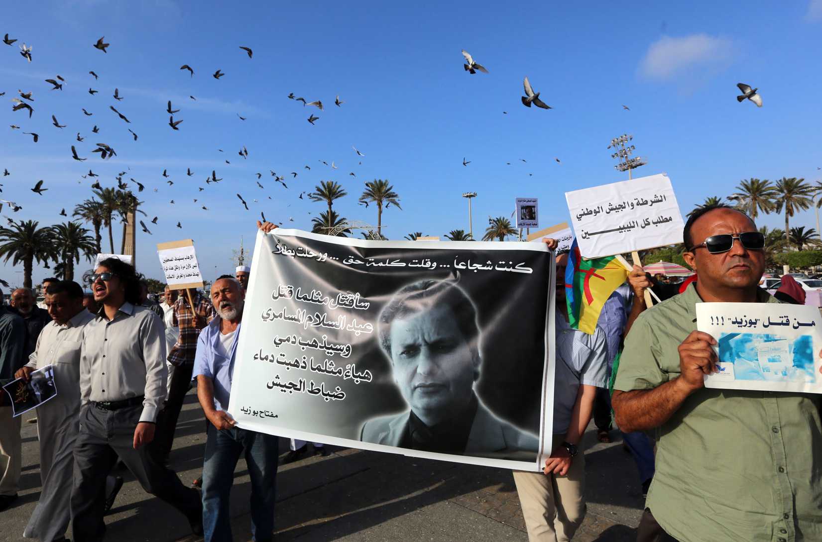 Journalists and others take part in a rally at Tripoli's Martyrs' Square on May 26, 2014