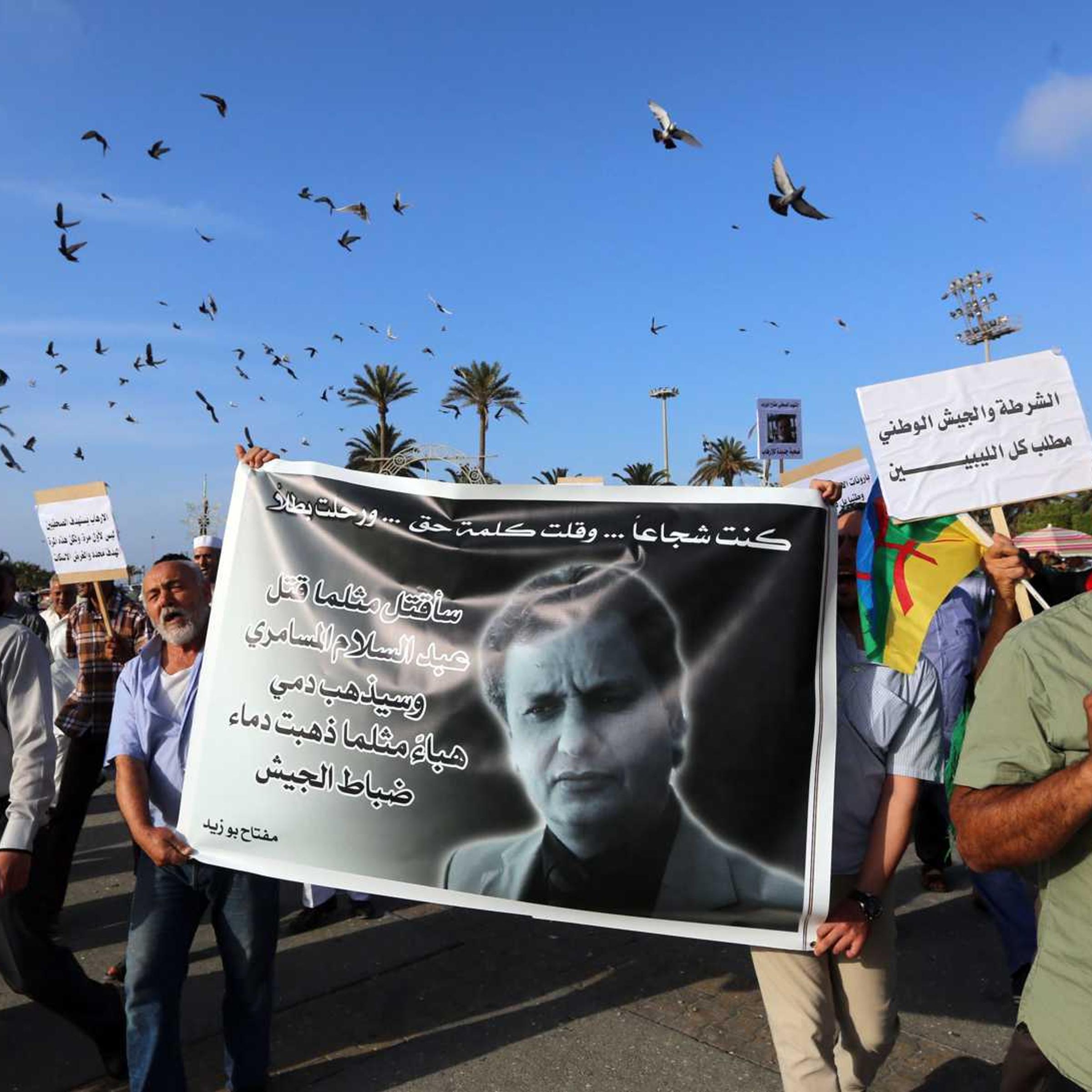 Journalists and others take part in a rally at Tripoli's Martyrs' Square on May 26, 2014